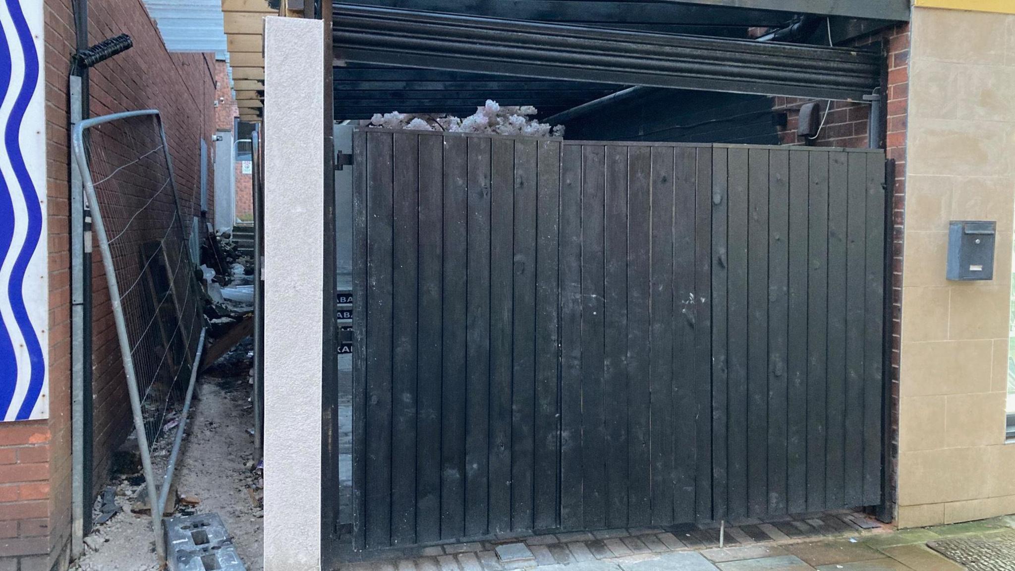 The covered seating area at Trinity Lounge has to be pulled down because it encroaches on a public alleyway.