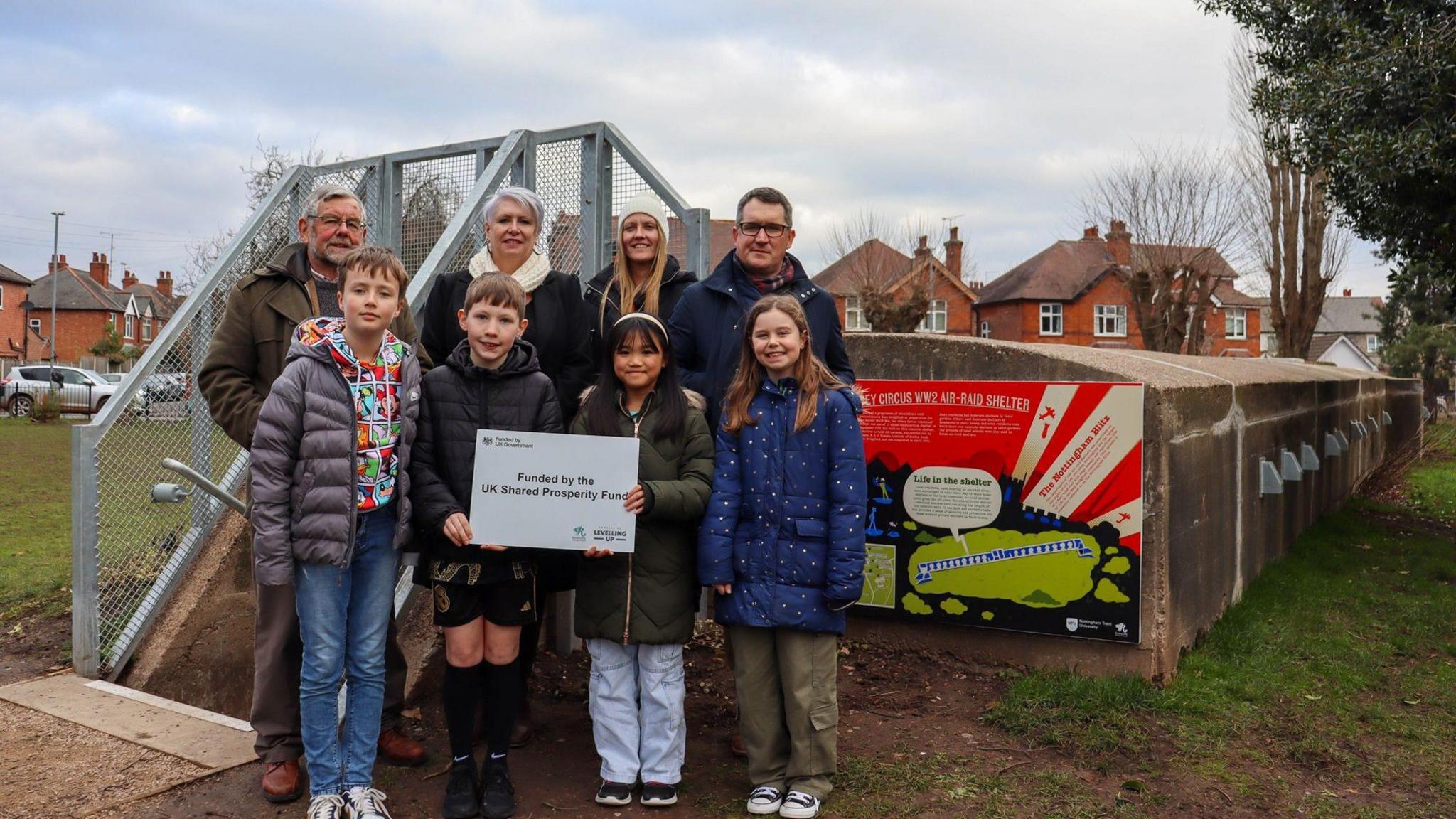 Four children at the front of the image are from St Edmund Campion Catholic Voluntary Academy. Adults from left to right - Project partner Jason King, Mrs Dawson from St Edmund Campion Catholic Voluntary Academy, Councillor Abby Brennan of Rushcliffe Borough Council, Professor Chris Reynolds of NTU.