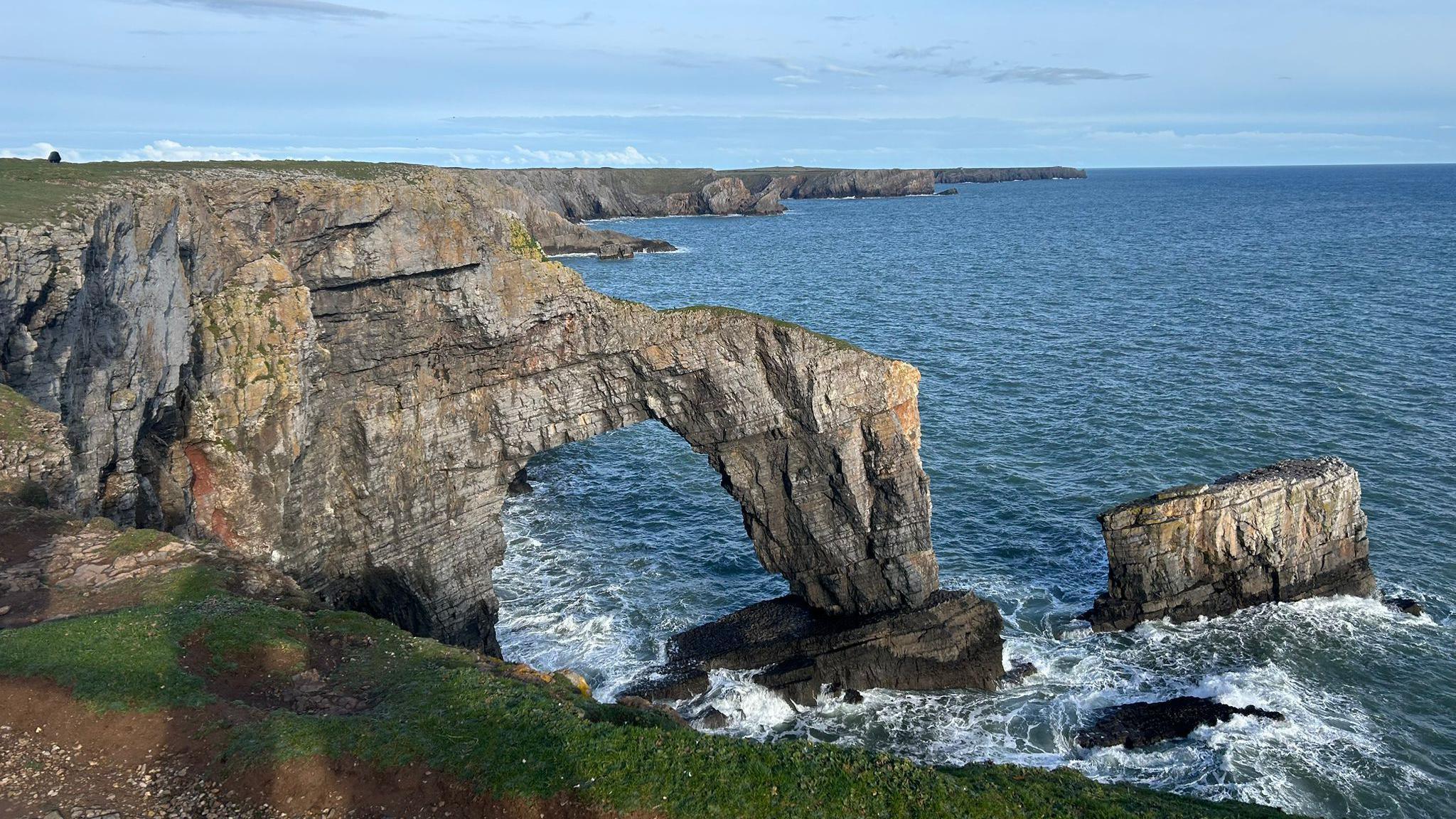 A section of British coastline that includes the Green Bridge of Wales rock arch