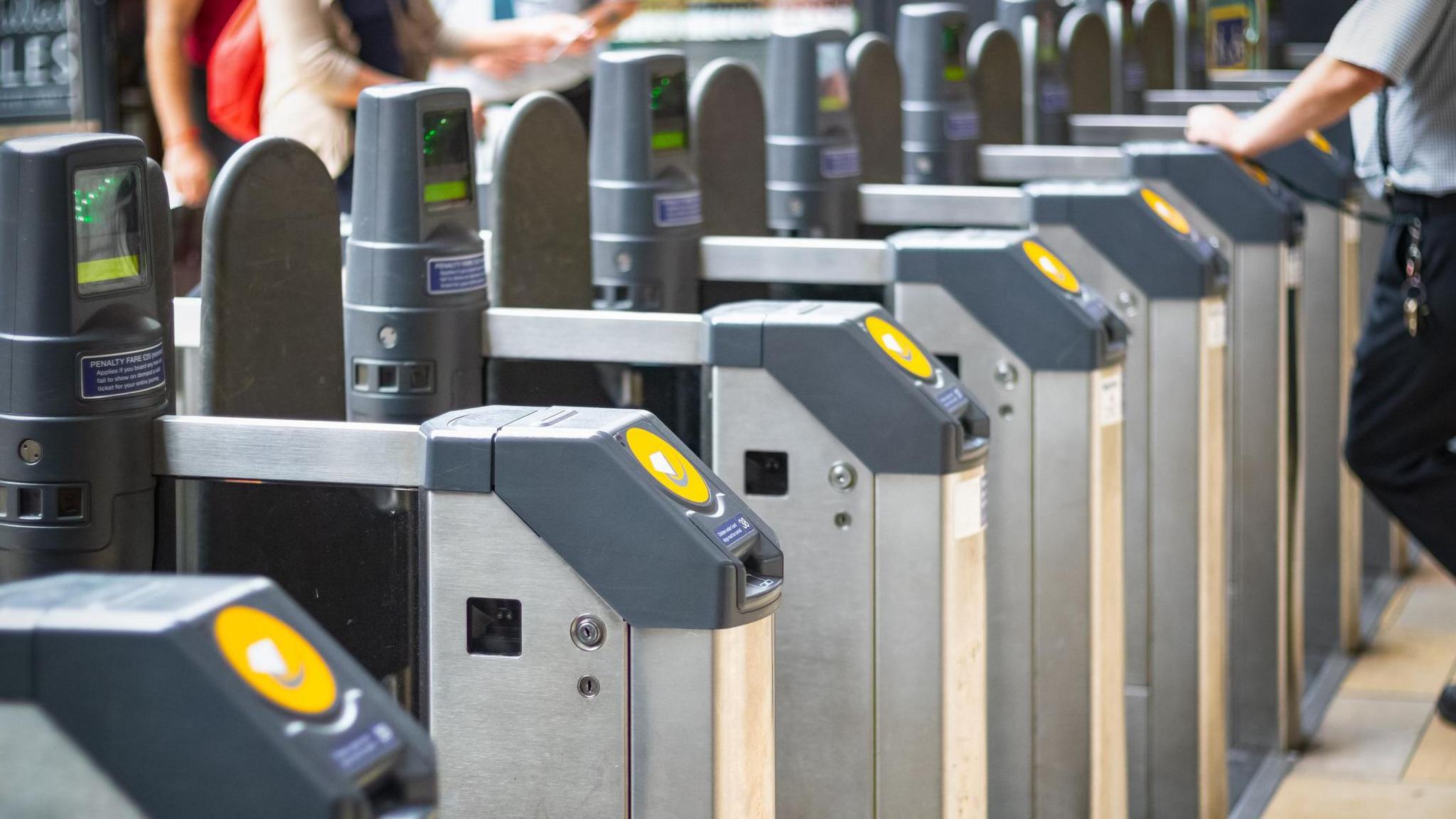 A row of Tfl ticket barriers at a station 