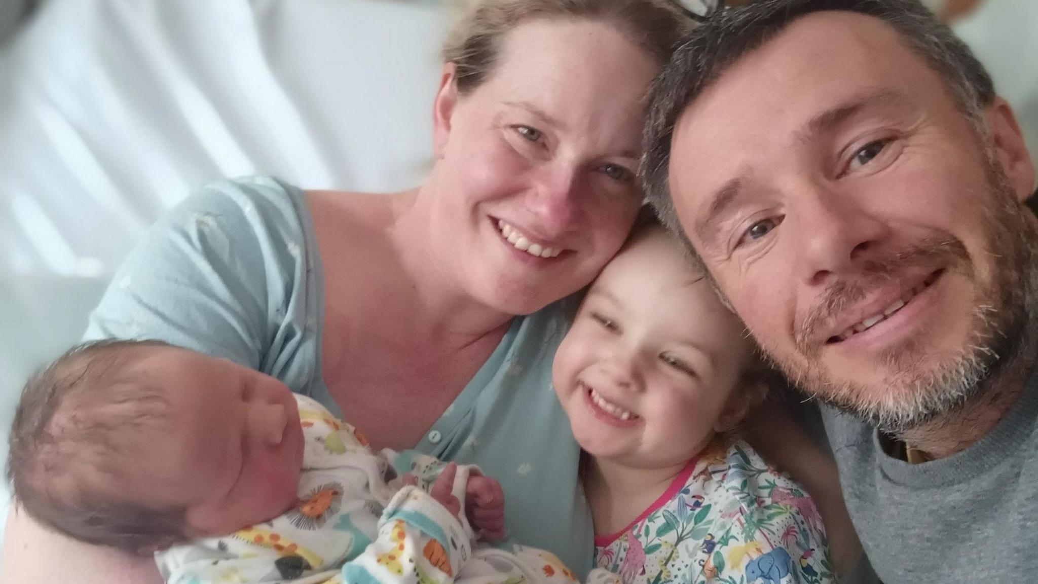 Selfie photo of Maria Moynihan, her husband Danny Riordan, their three-year-old daughter Fallon and their newborn son Caoilte who was born in August.   The family are sharing a cuddle on Maria's bed shortly after the birth.