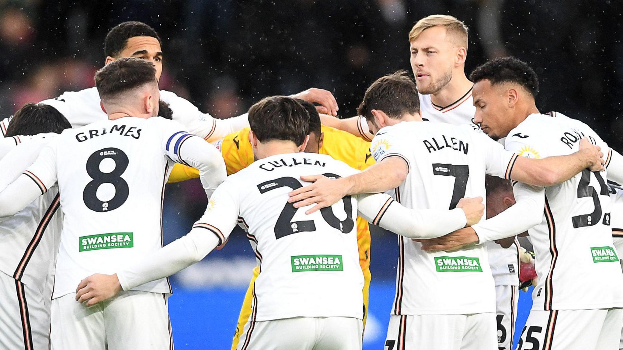 Swansea City players in a huddle