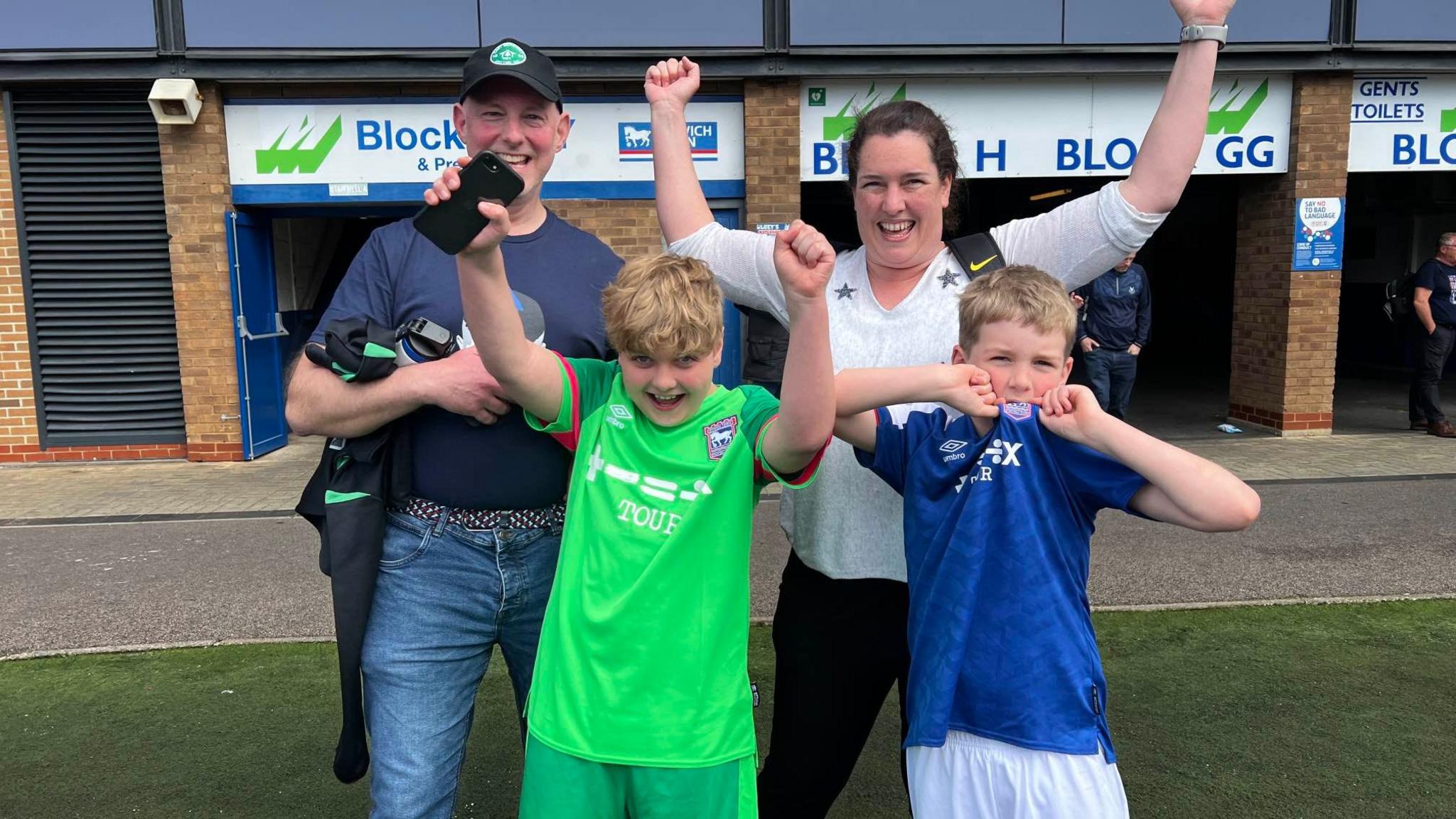 A dad, mum and two sons celebrating Ipswich's win 