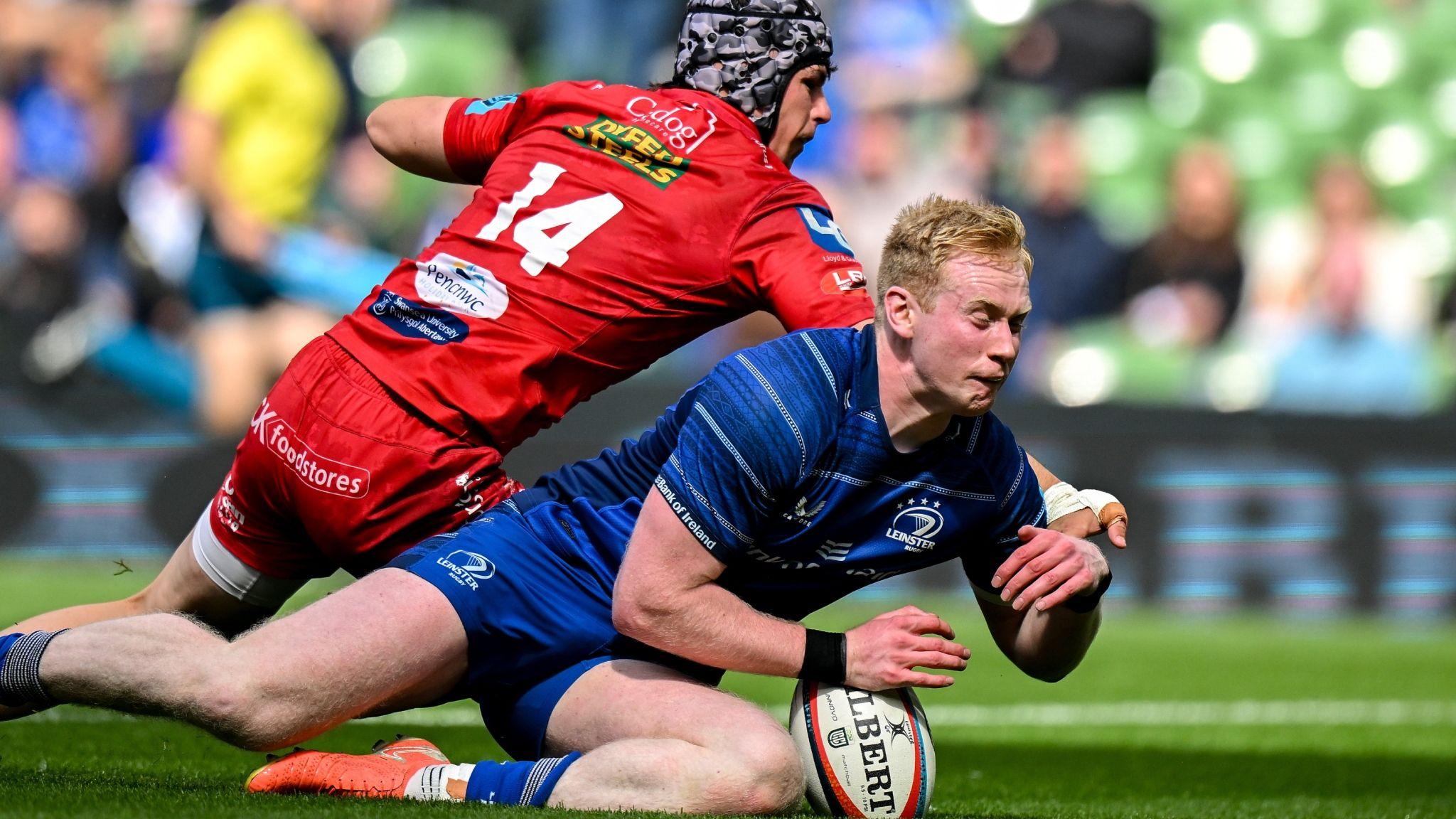 Jamie Osborne of Leinster scores his side's third try despite the efforts of Tom Rogers of Scarlets during the United Rugby Championship quarter-final match between Leinster and Scarlets at the Aviva Stadium in Dublin. 