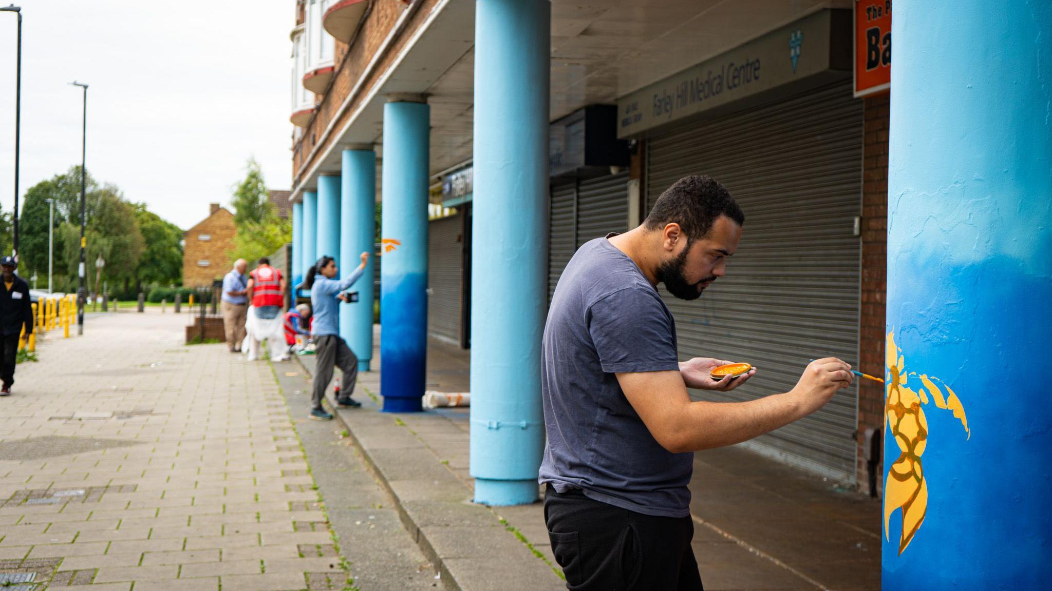 People painting pillars in Farley Hill, Luton