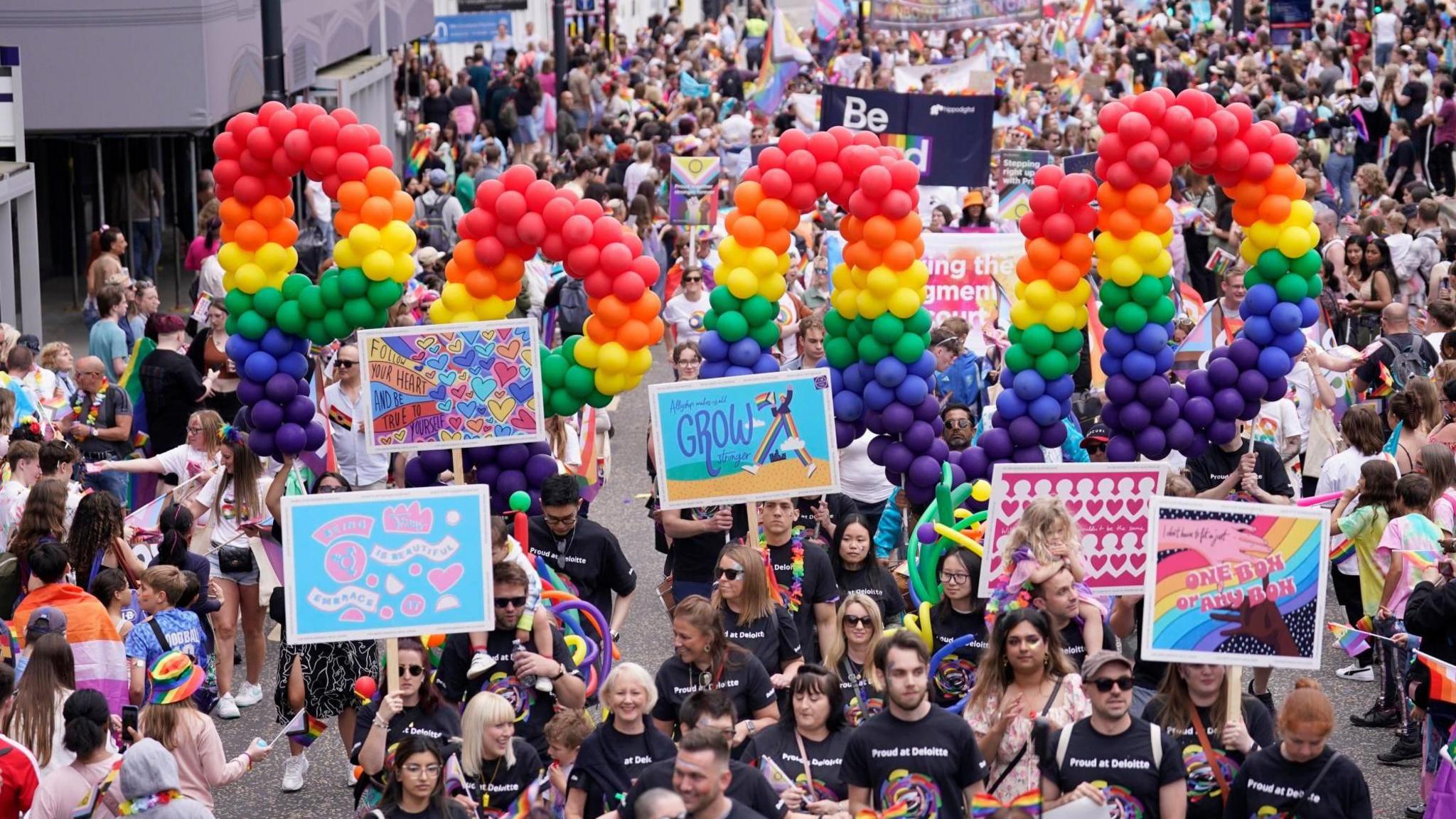 A rainbow balloon display showing the word proud