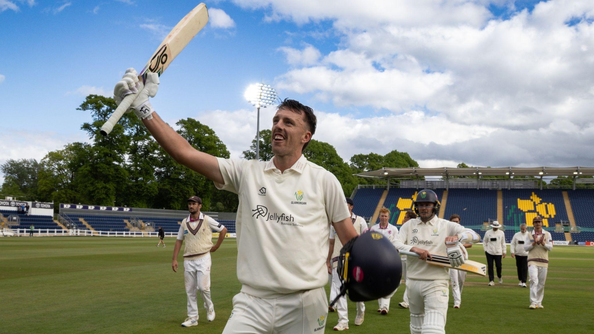 Ryan Hadley raises his bat as he walks off followed by Glamorgan team-mates