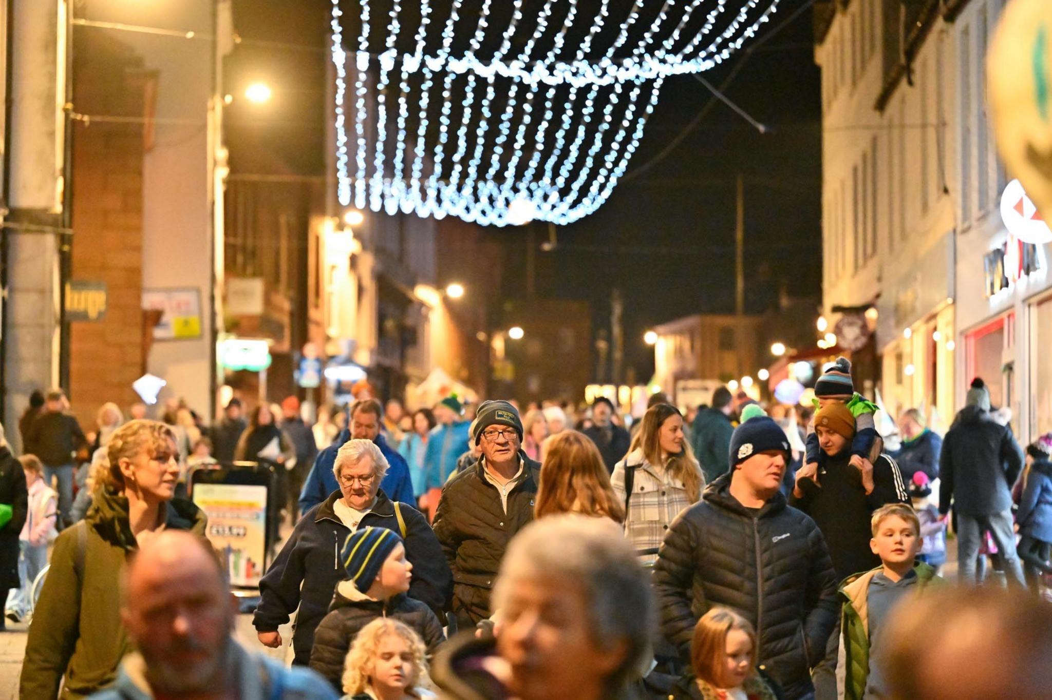 Groups of spectators make their way home following a carnival in Dumfries town centre