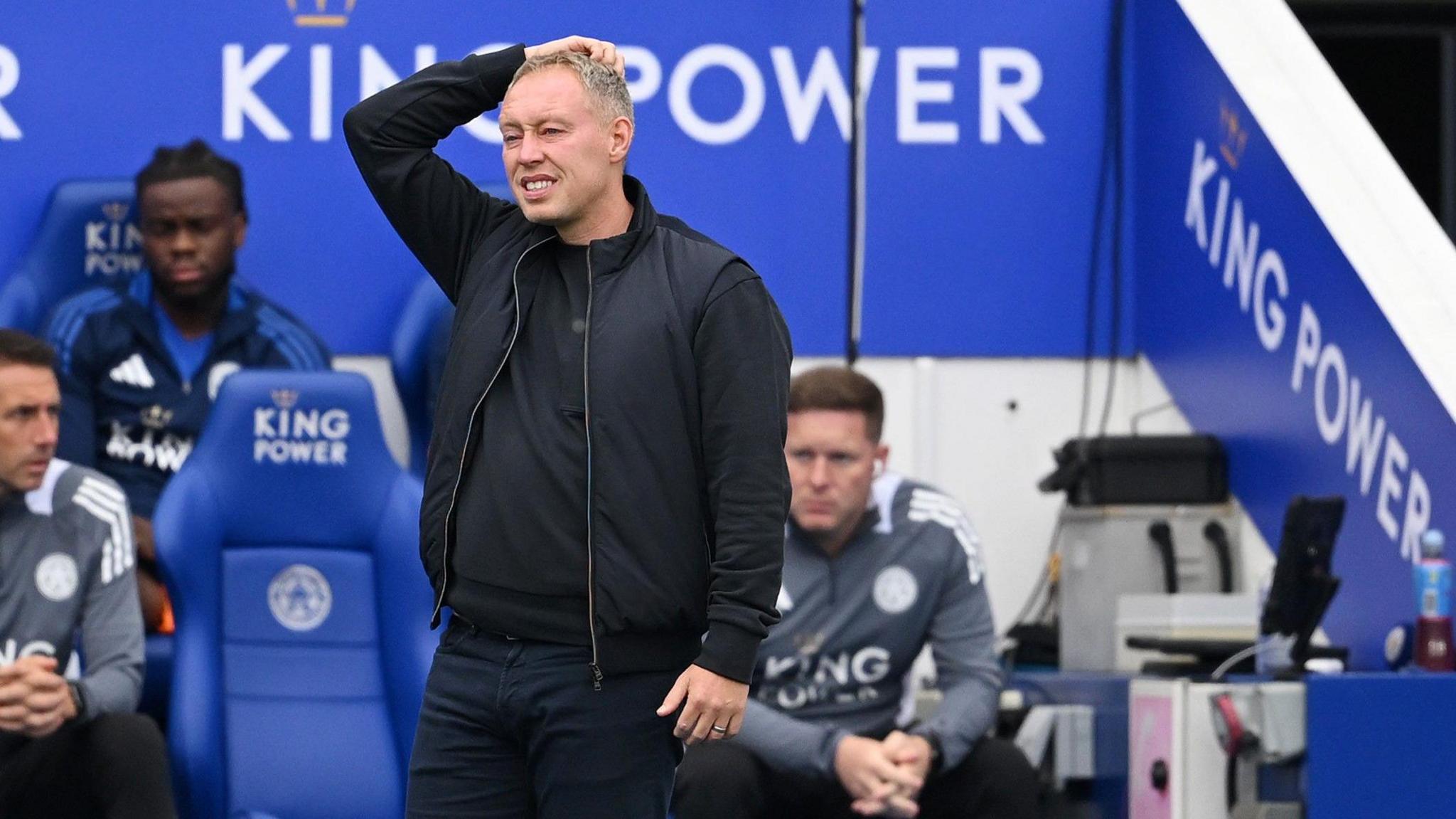 Steve Cooper puts his right hand on his head as he watched Leicester play Aston Villa.