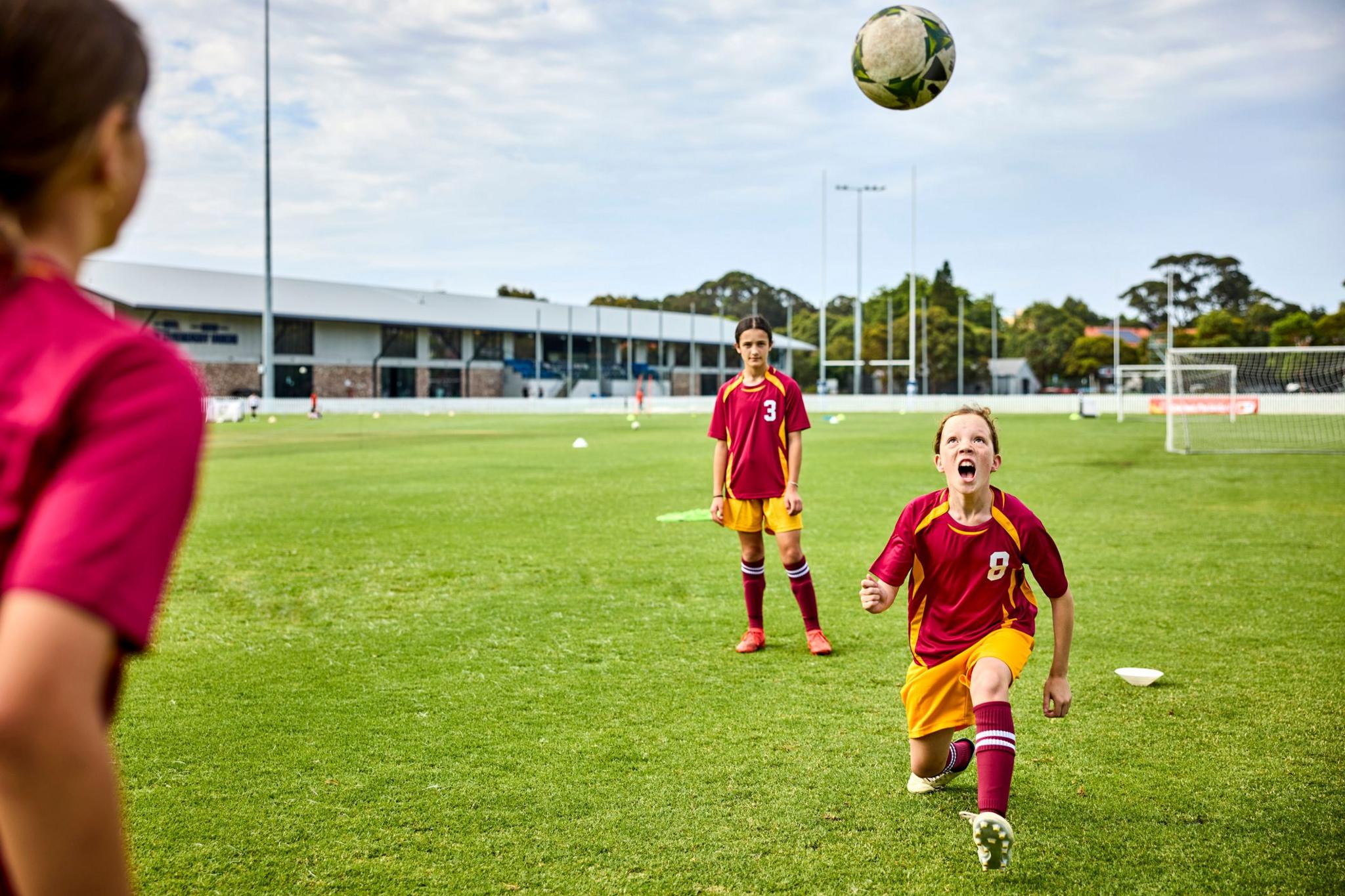 A child heads a football during a training session
