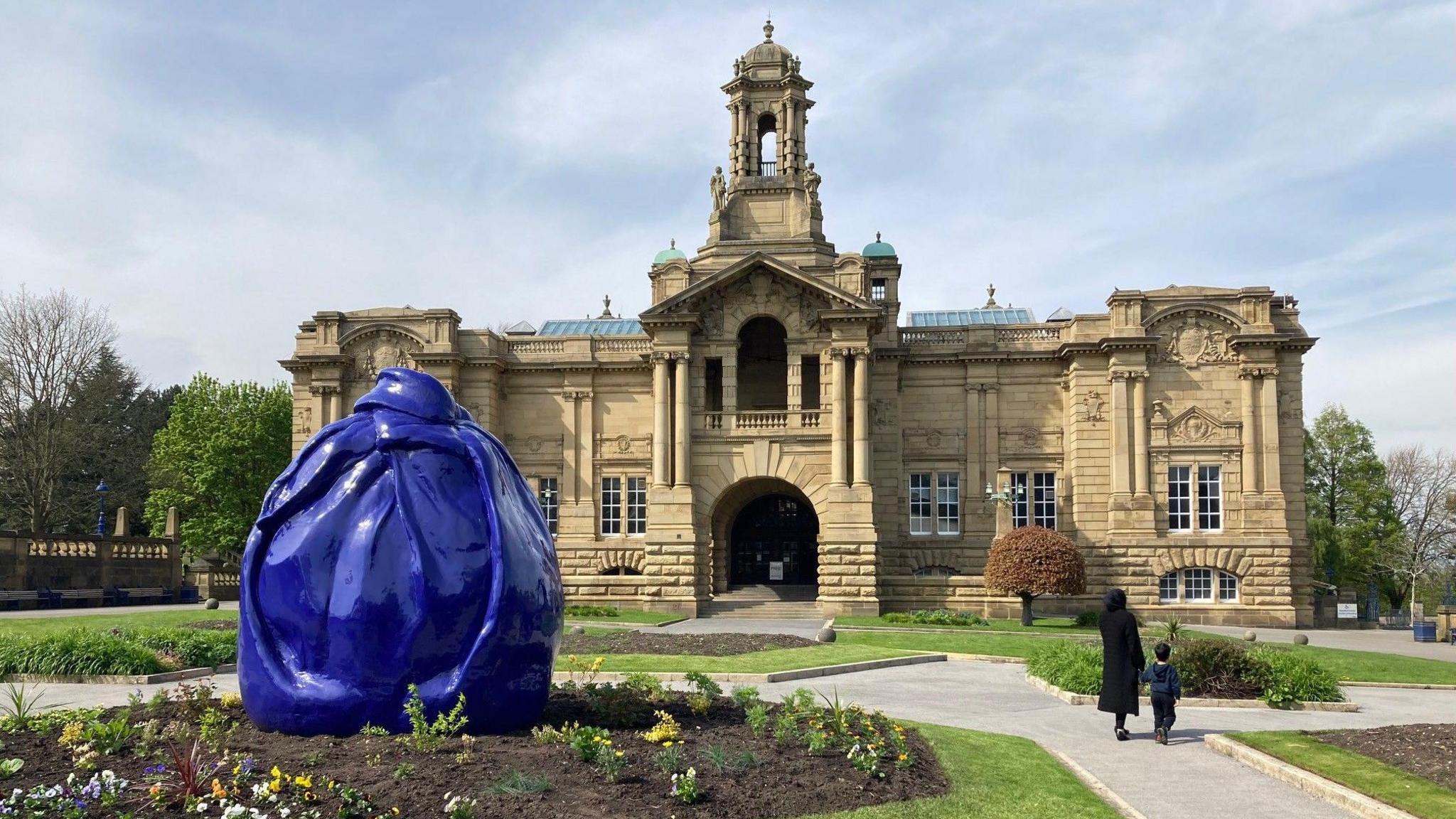 A blue temporary cover over the bronze sculpture Diana the Huntress in Lister Park