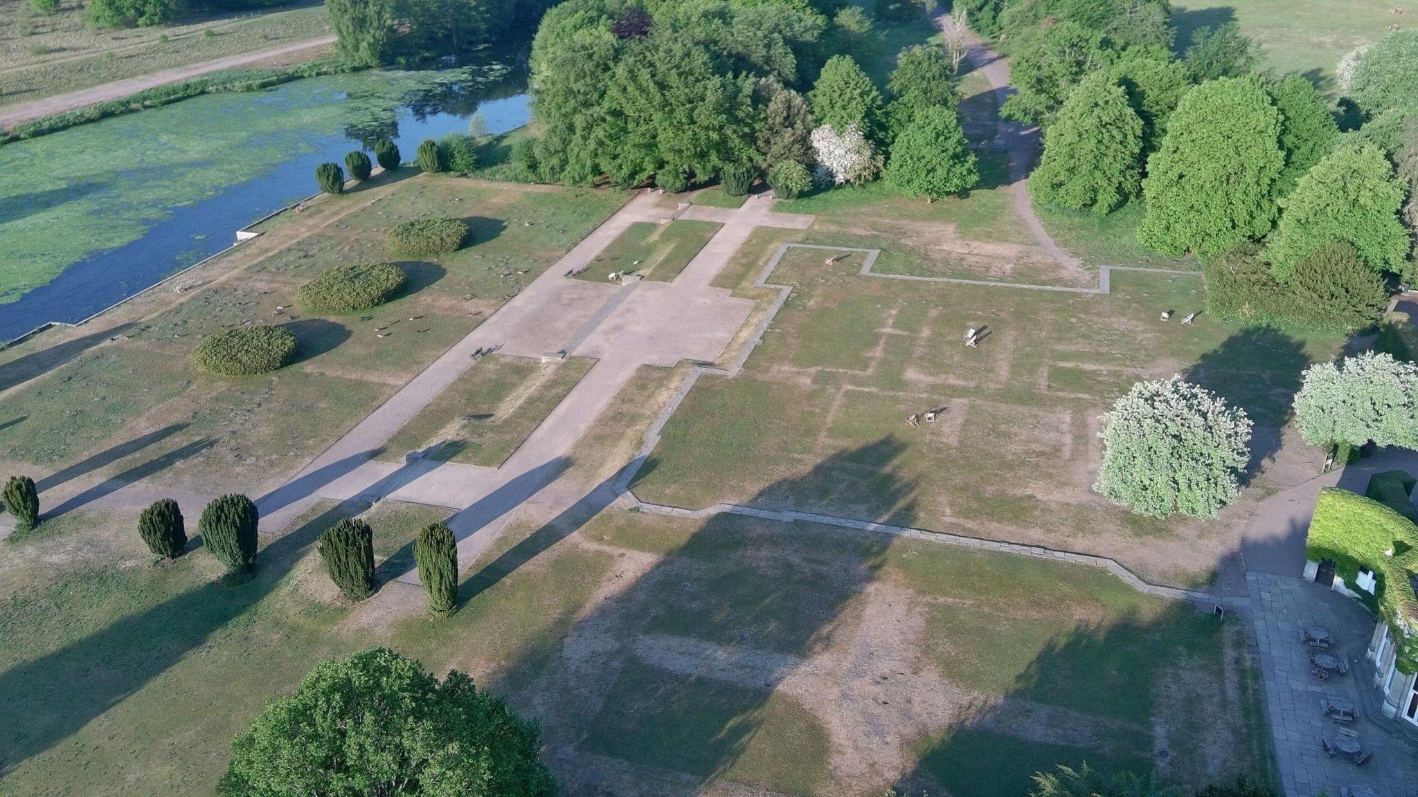 A drone shot of outlines in the parched grass