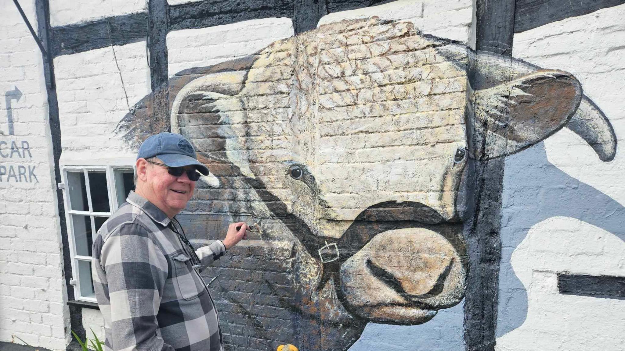 Phil Taylor painting the mural