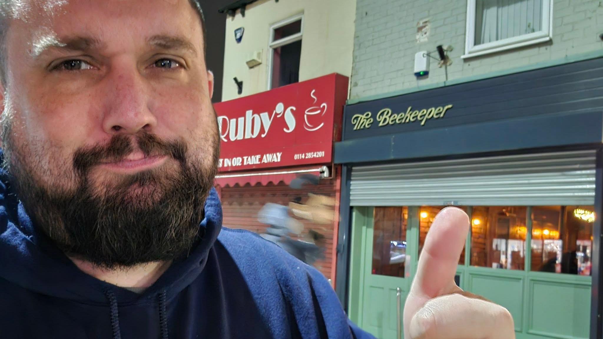 Dale stands in front of a pub called The Beekeeper in Sheffield