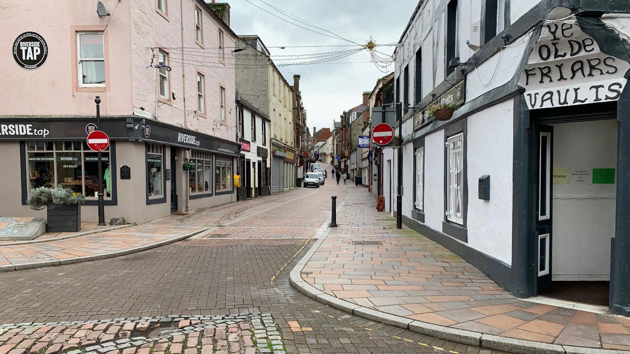 A picture of Friars Vennel a narrow road wending its way through Dumfries with a paved roadway