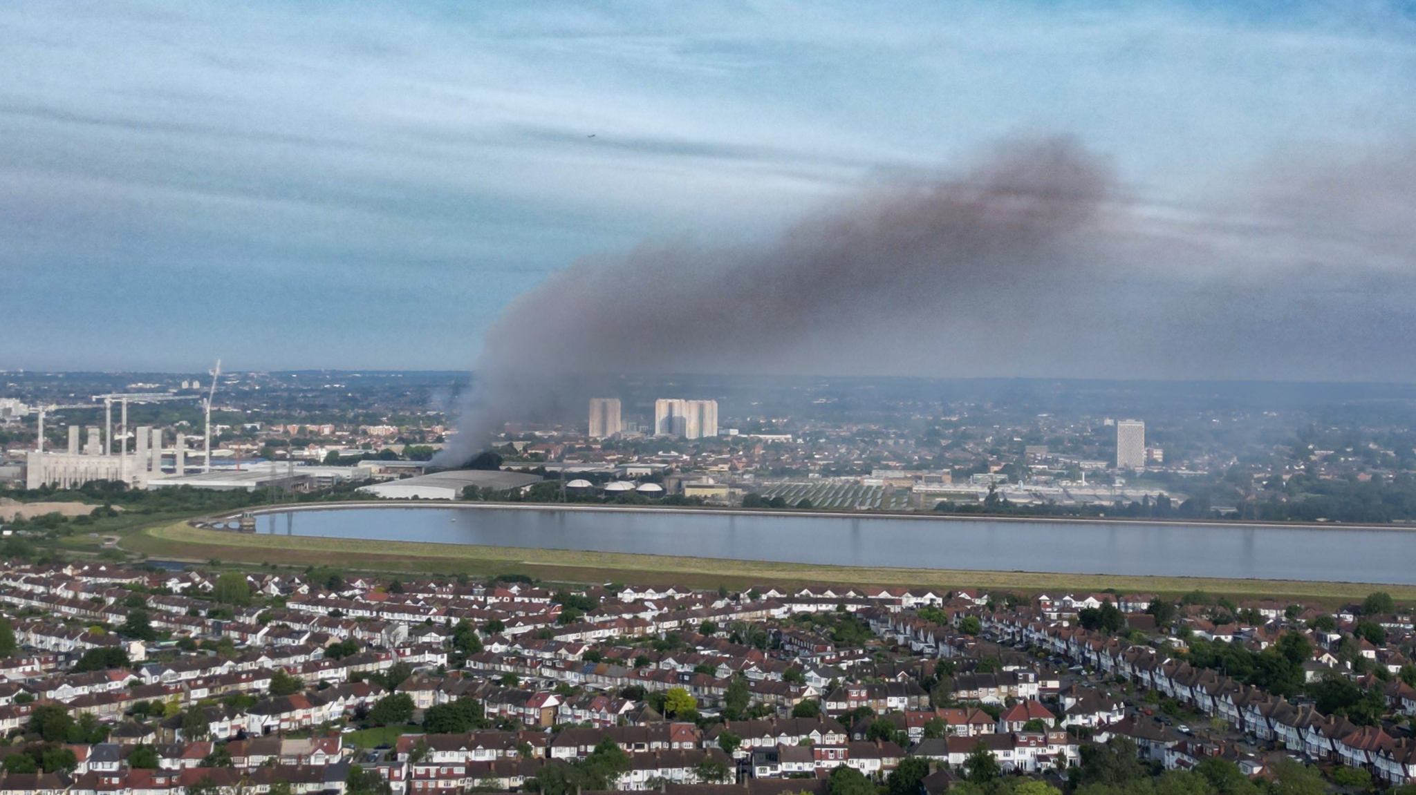 Smoke rising from behind a lake