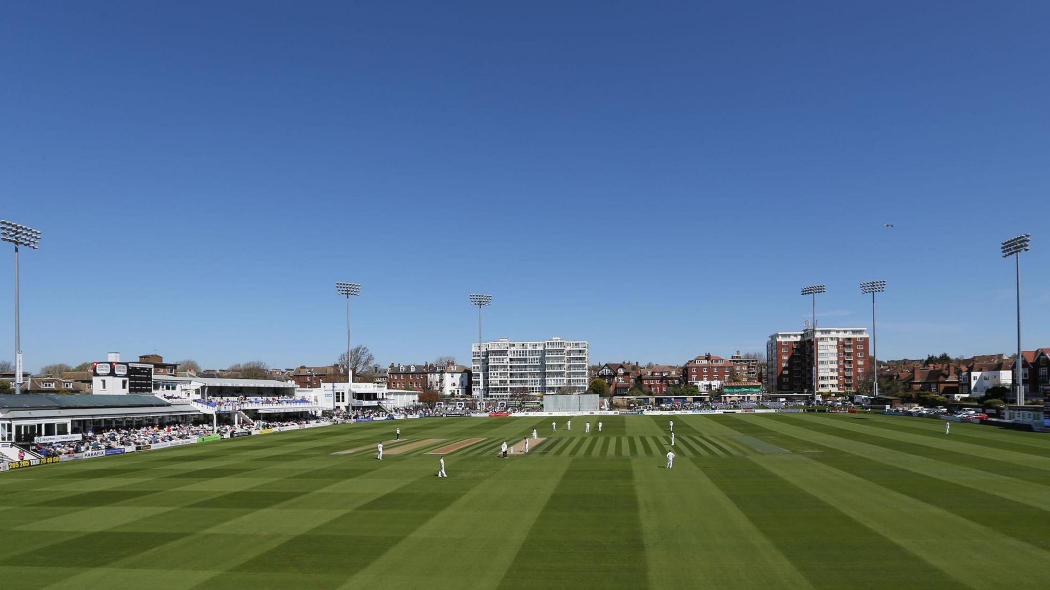 Sussex's Hove cricket ground under blue skies and players out on field in whites