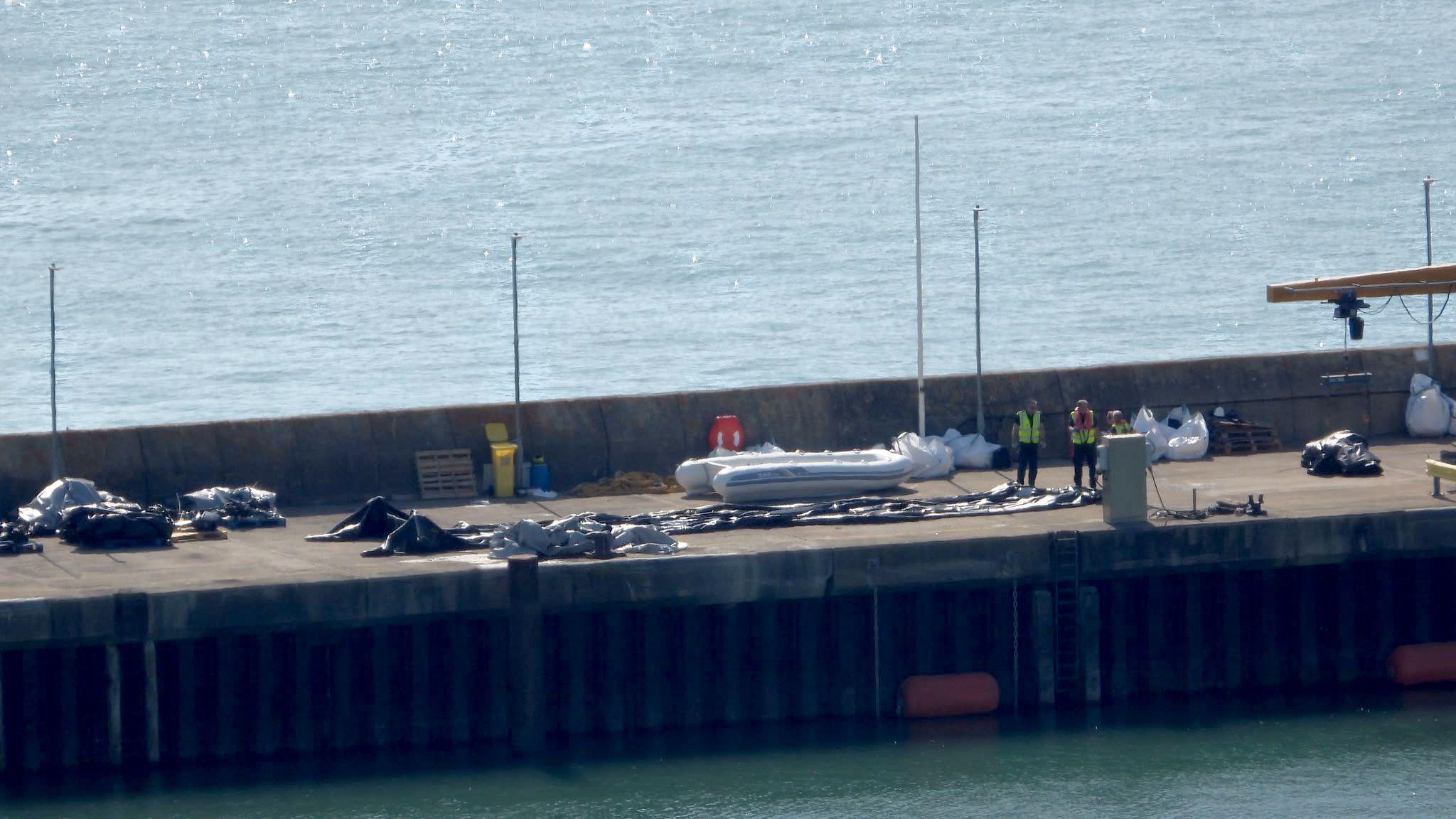 A deflated dinghy is seen on the quayside in Dover, Kent. A record 230 migrants arrived after crossing the Channel to the UK in a single boat on Monday