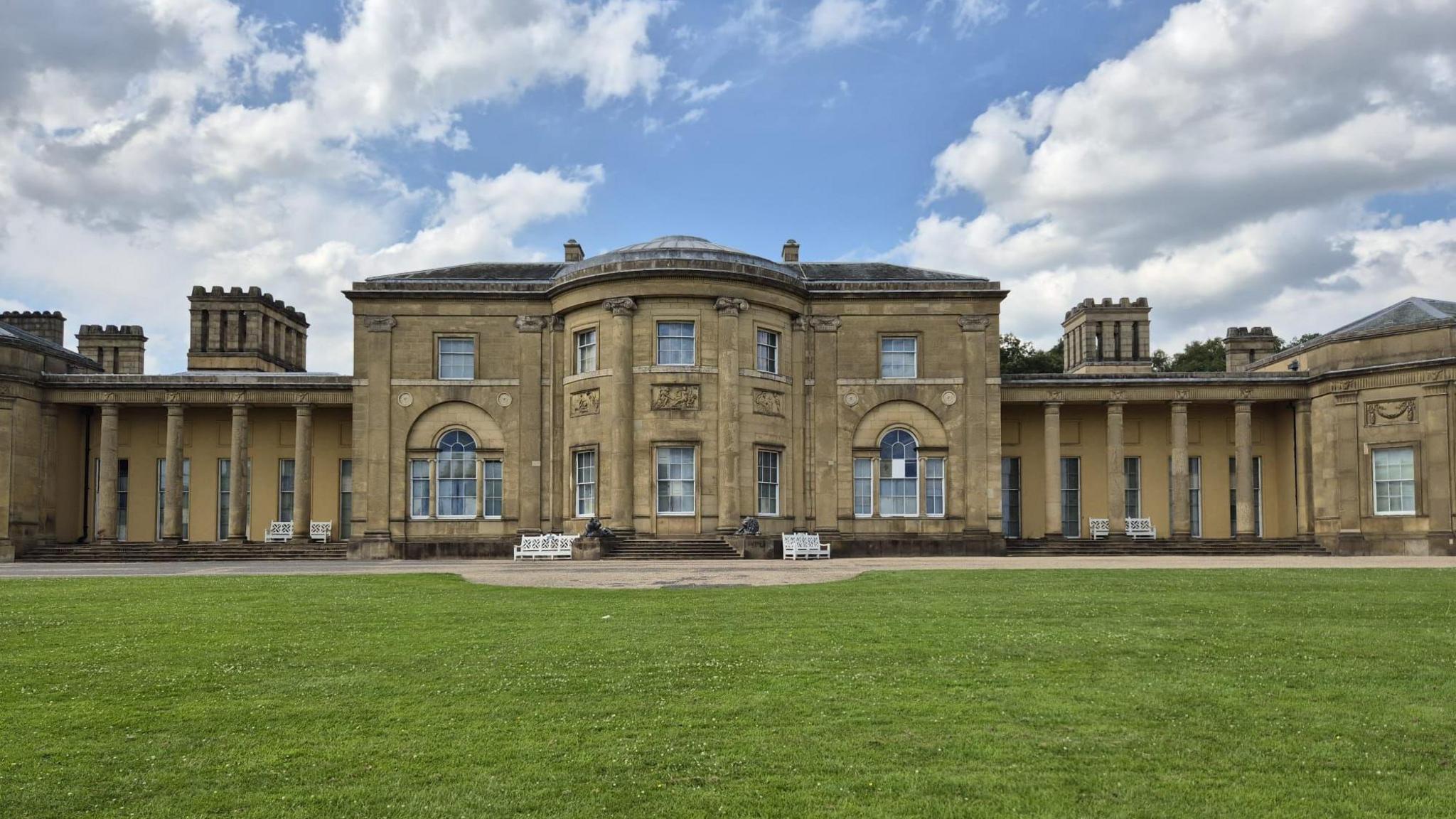 Honey-coloured neoclassical pillars on either side of the front of Heaton Hall. It looks out over a green lawn