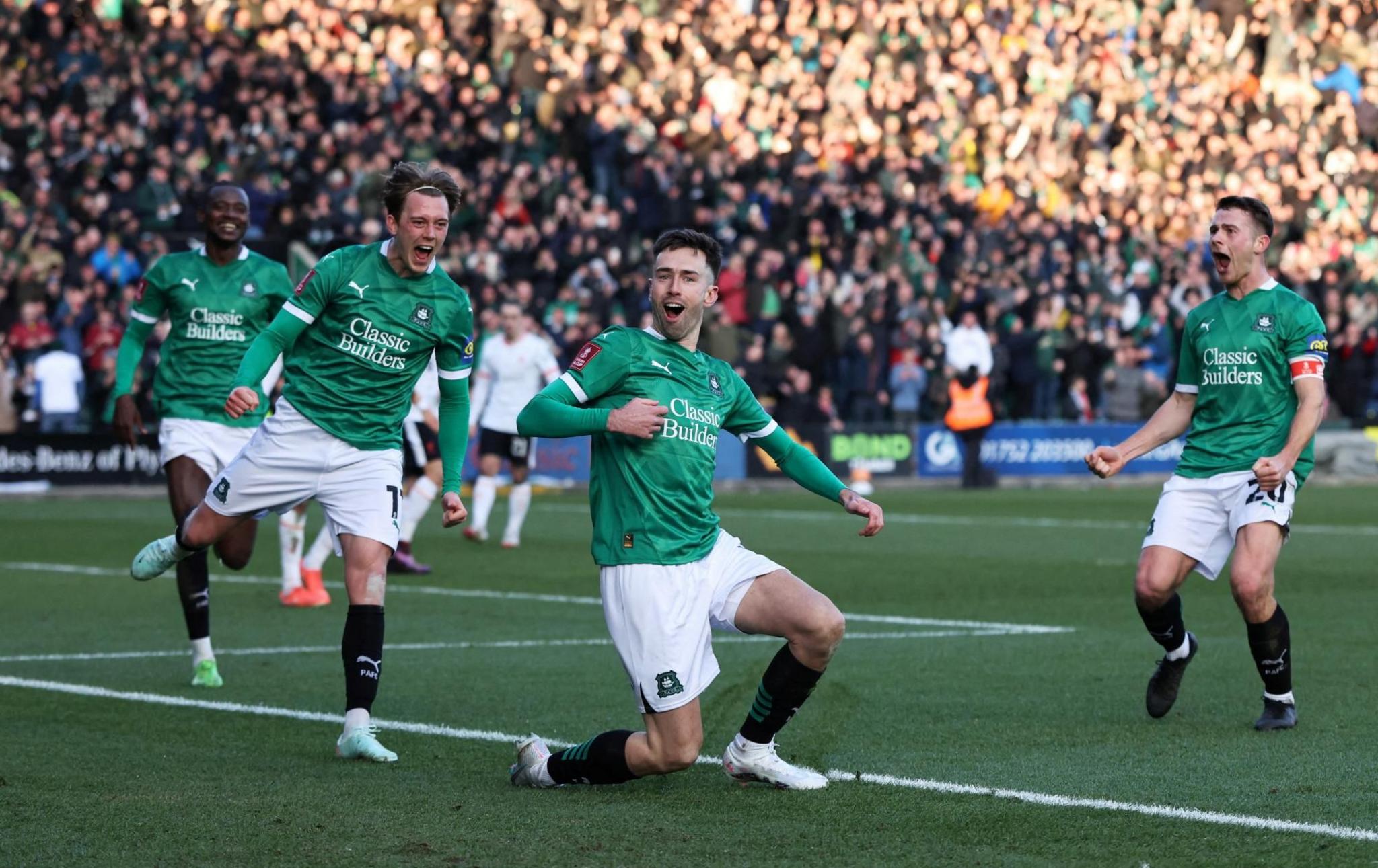 Plymouth Argyle's Ryan Hardie celebrates scoring a goal as teammates Callum Wright and Adam Randell move towards him
