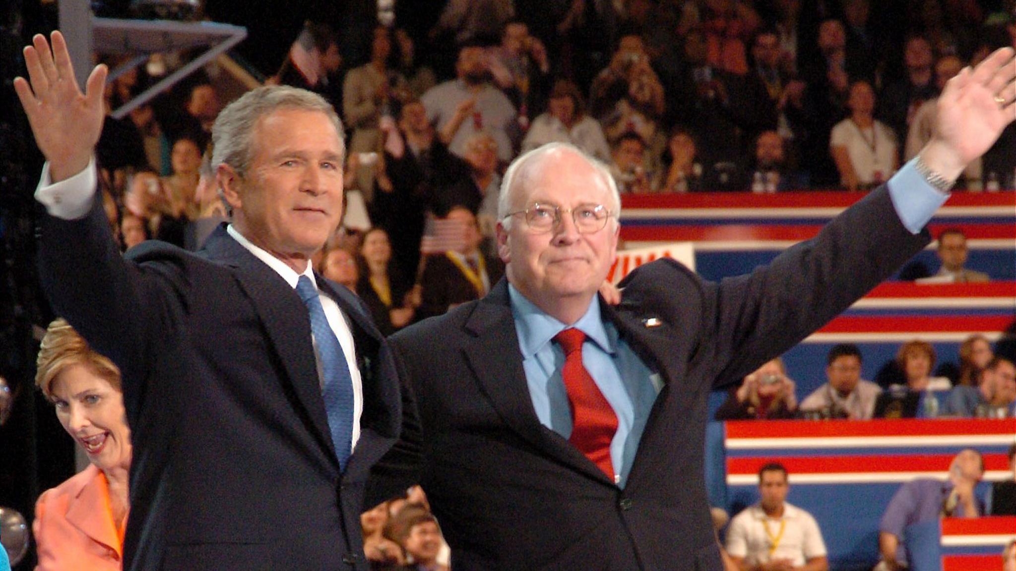 George W Bush and Cheney at the Republican National Convention in 2004, with their arms around each other and waving to the crowd with the other hand