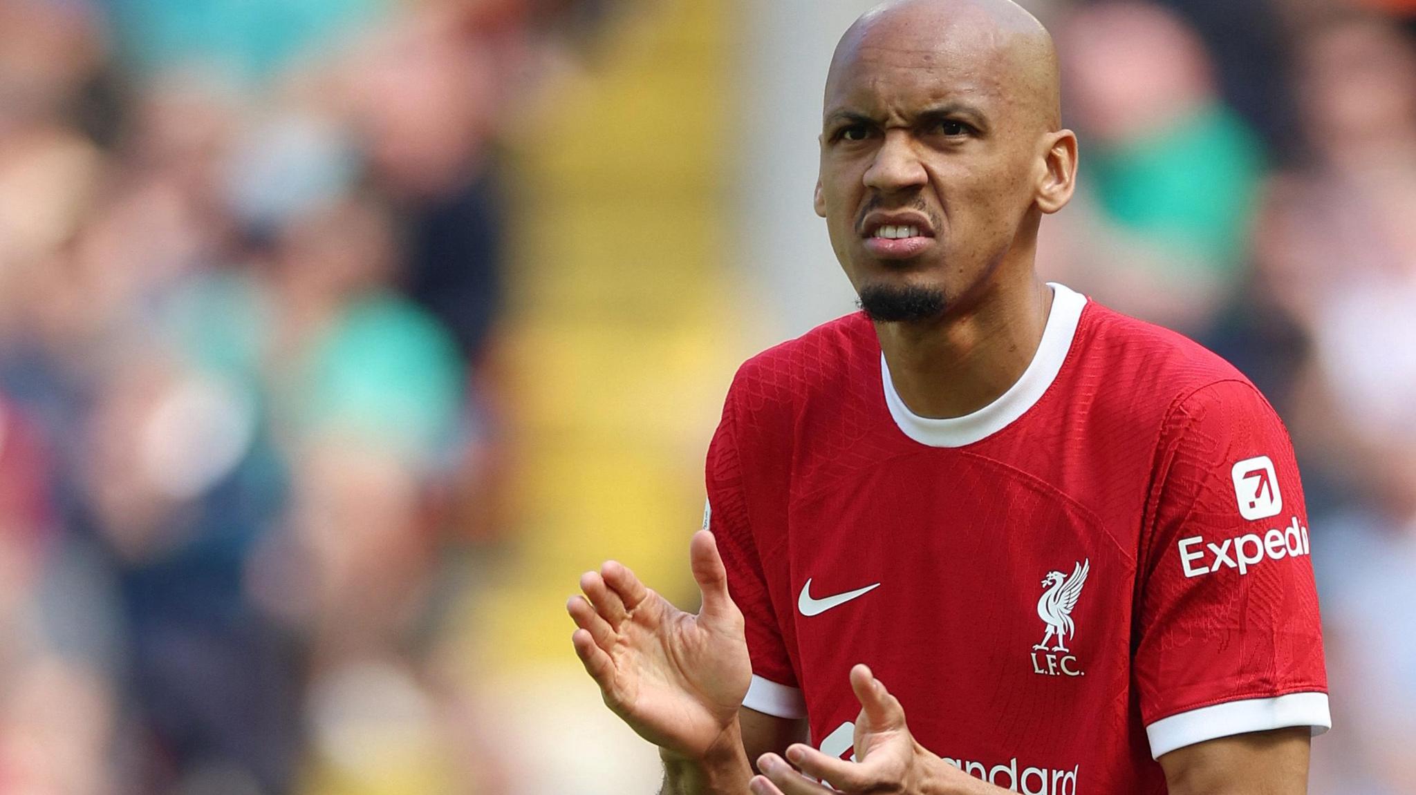 Fabinho applauds while in action for Liverpool