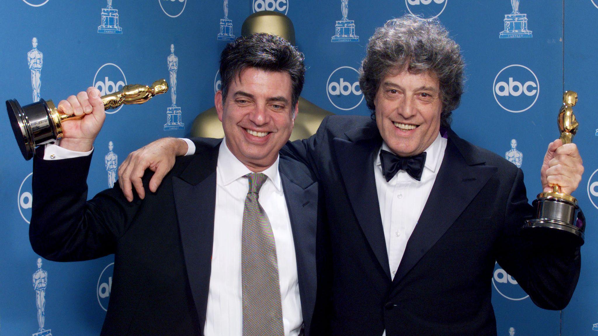 Screenwriters Marc Norman (L) and Tom Stoppard hold their Oscar statues backstage at the 71st annual Academy Awards in Los Angeles, 21 March, 1999.