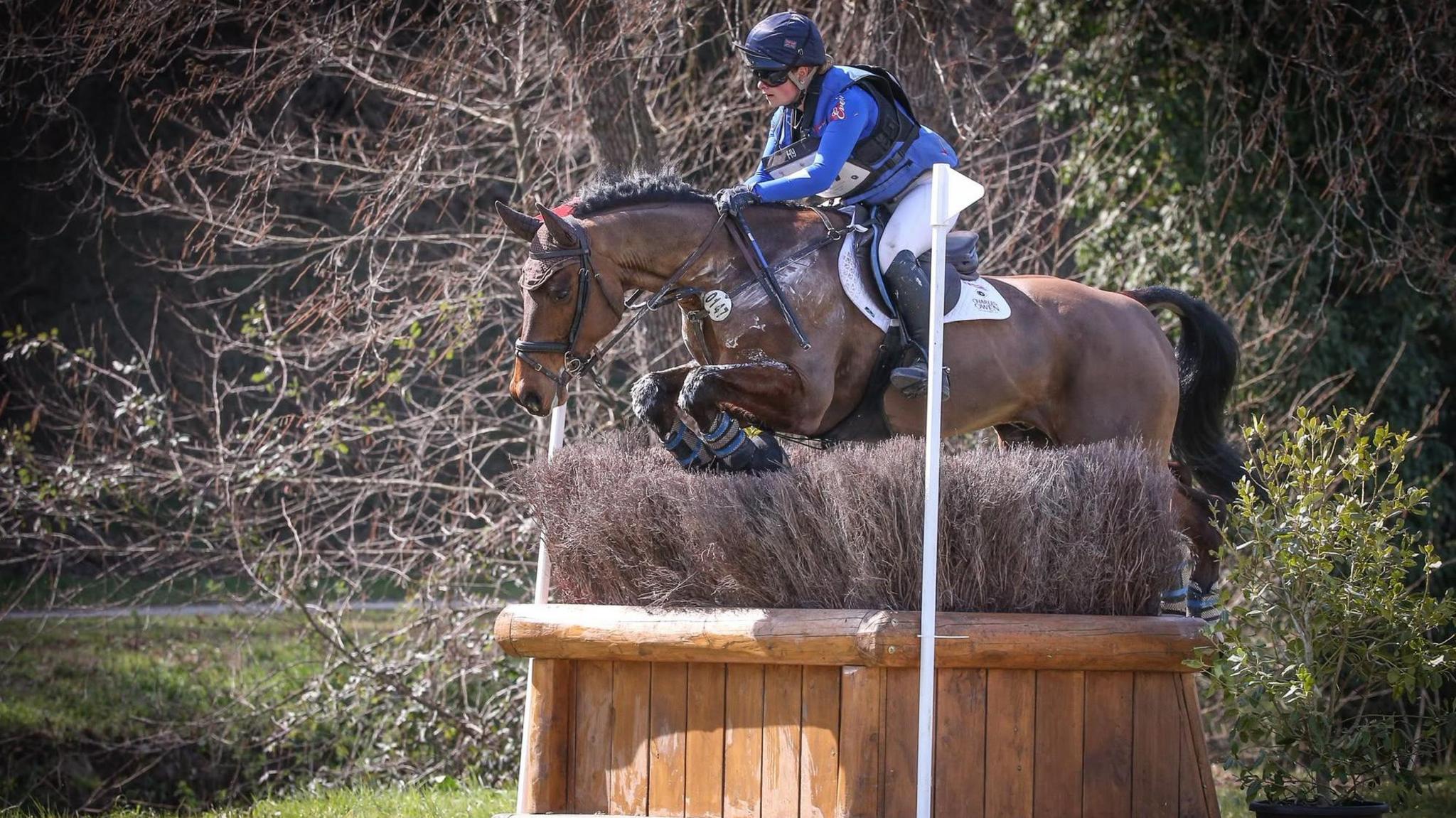 Saffron Cresswell and her horse jumping over a fence 