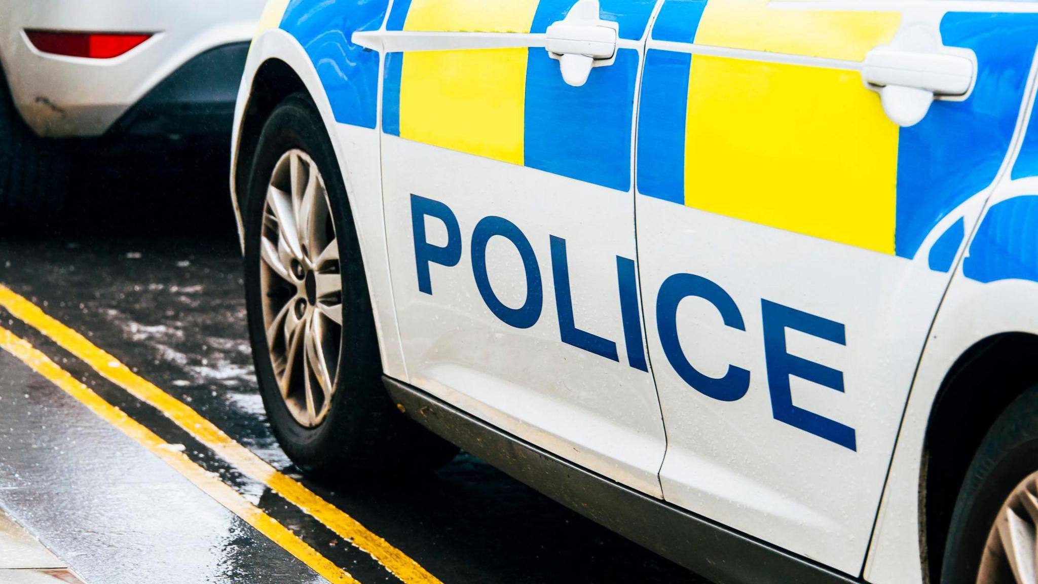 Police Scotland car parked behind another vehicle on a double yellow line