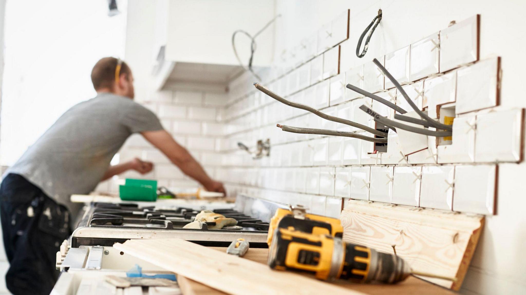 Man fitting a kitchen