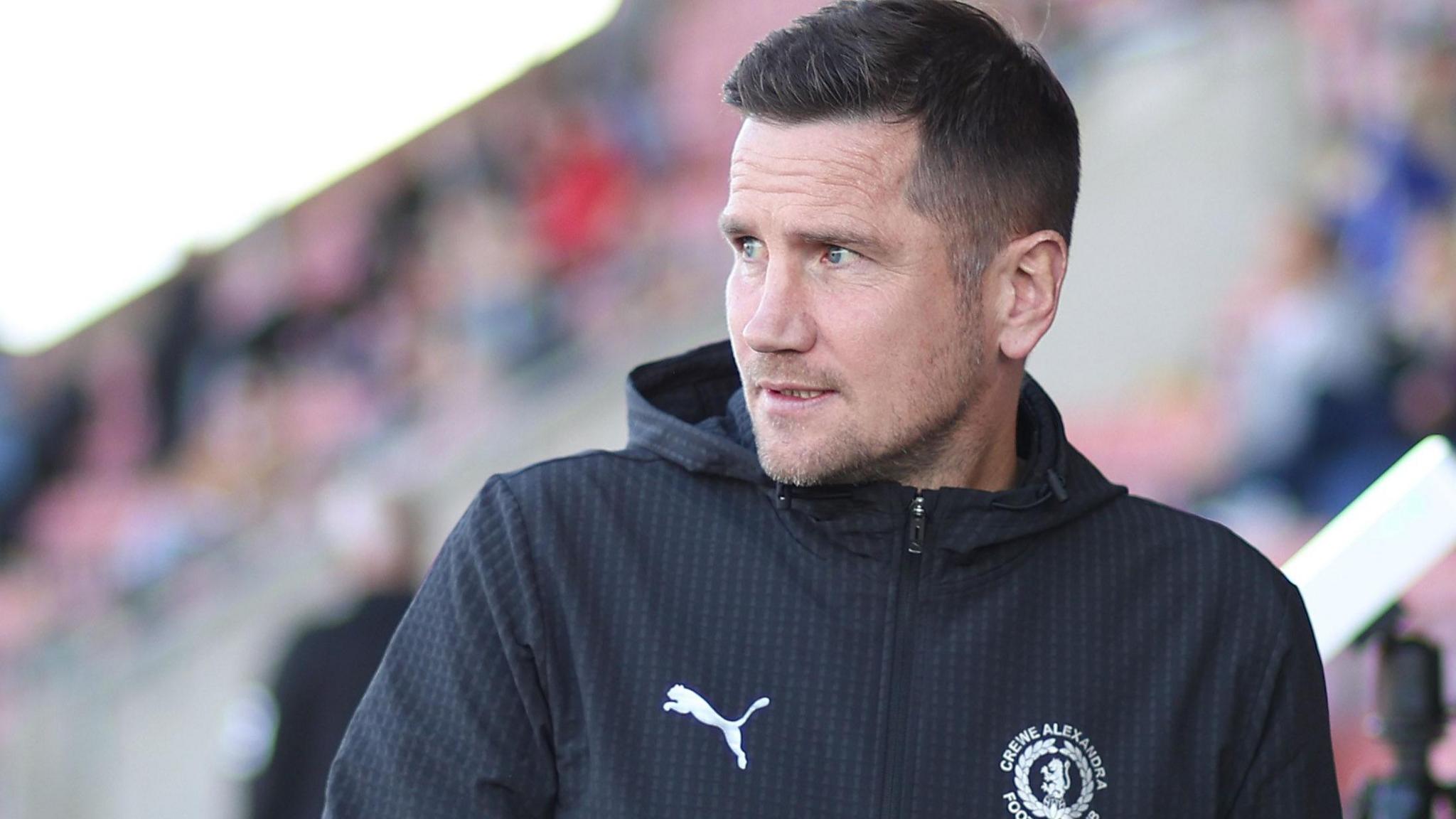 Lee Bell watches on from the touchline during a match