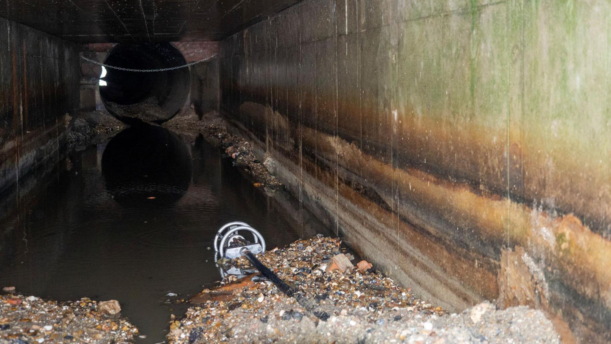 Dark and gloomy culvert which takes rainwater 