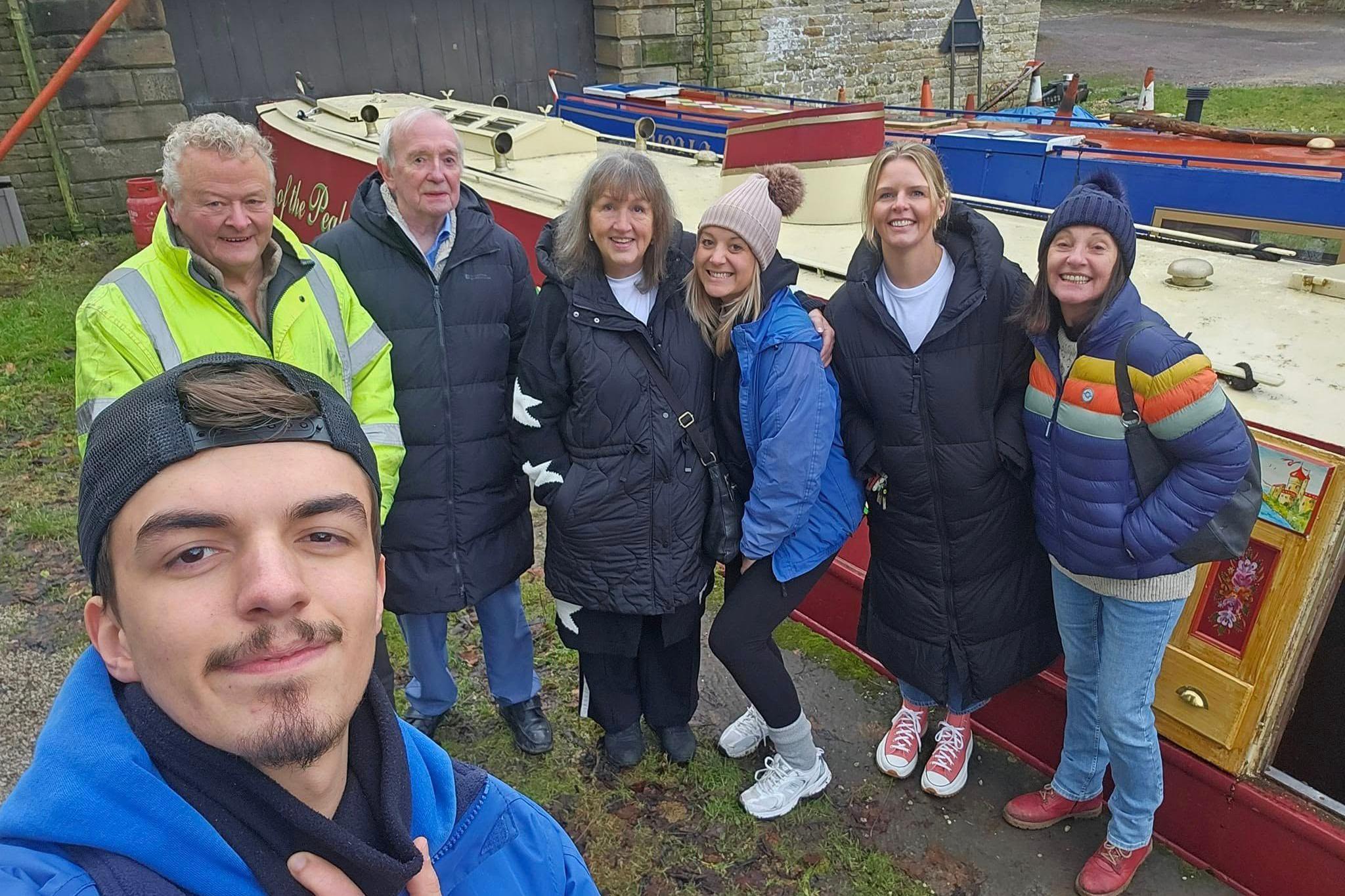 The narrowboat's new and old owners stand on the towpath shortly before the boat left Whaley Bridge