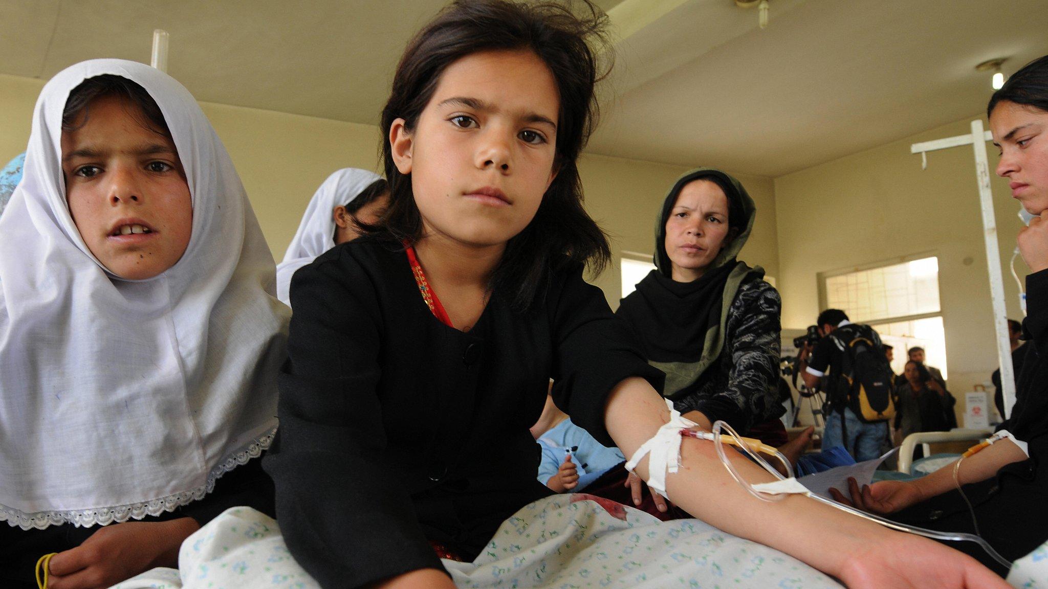 Afghan schoolgirls sit in a hospital in Mahmud Raqi