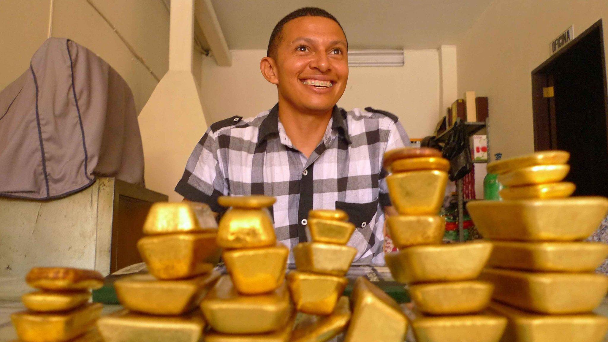 Trader Lucio Ruiz shows the gold bars that will be sold to major firms in Medellin