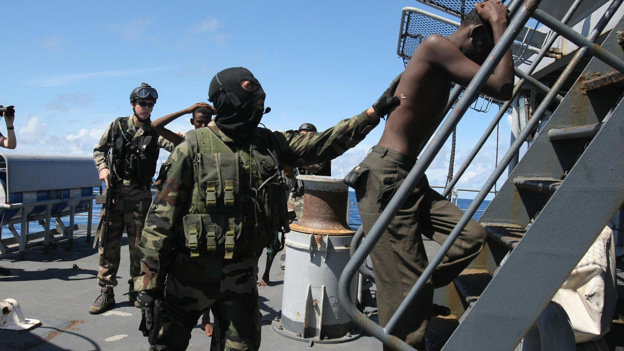 French soldiers escort suspected Somali pirates on board a warship in 2009 as part of an EU operation