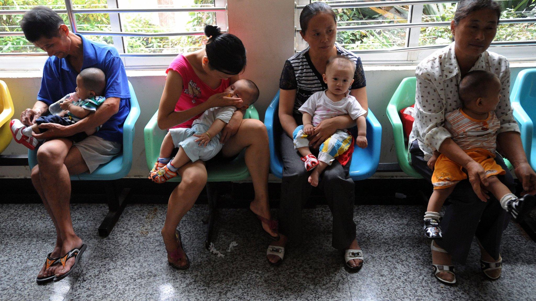 People holding babies who drank tainted milk powders queue to receive examination in a Hospital in Wuhan, China, 17 Sept 2008