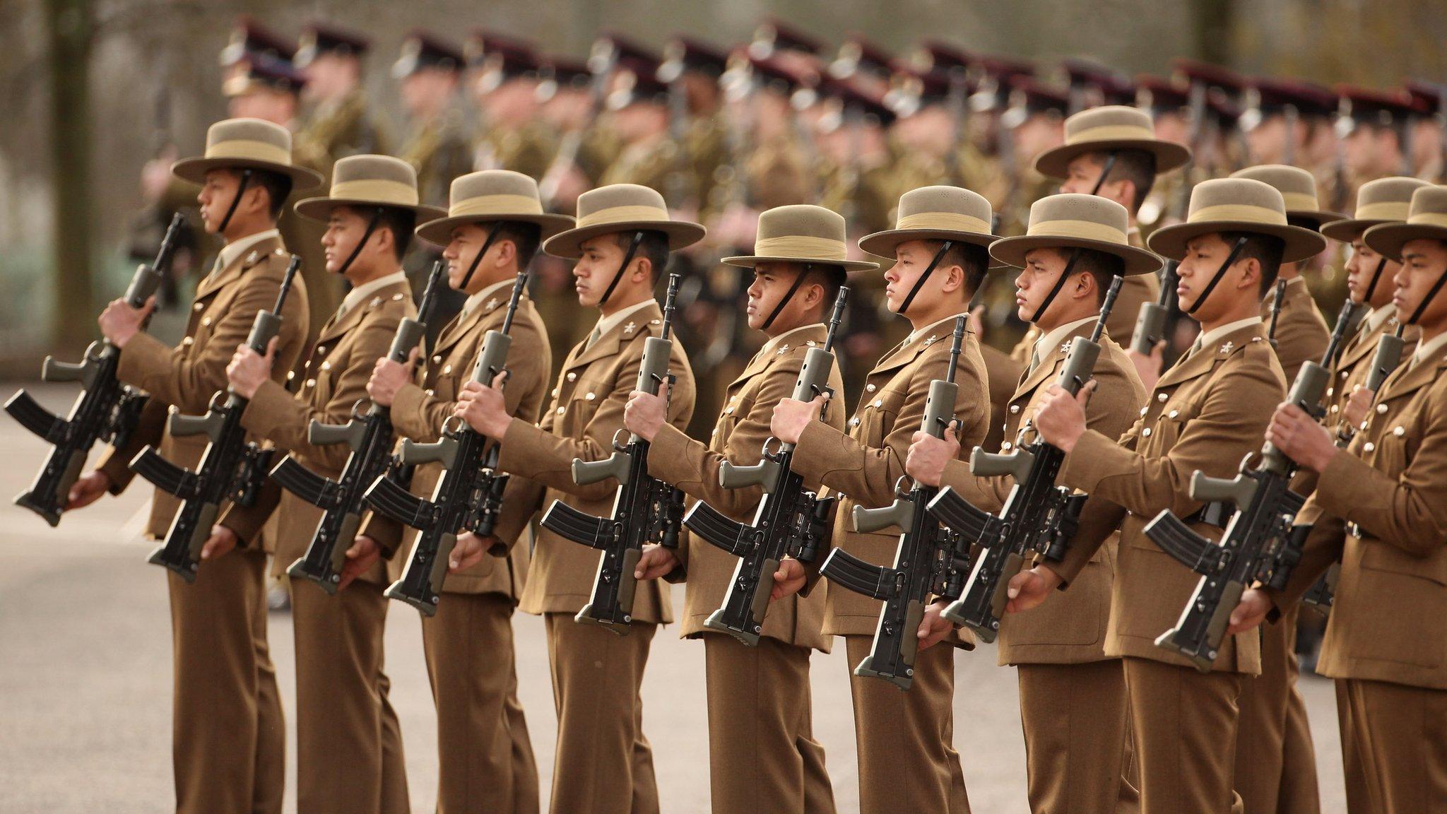 Soldiers in The Queen's Gurkha Engineers stand to attention