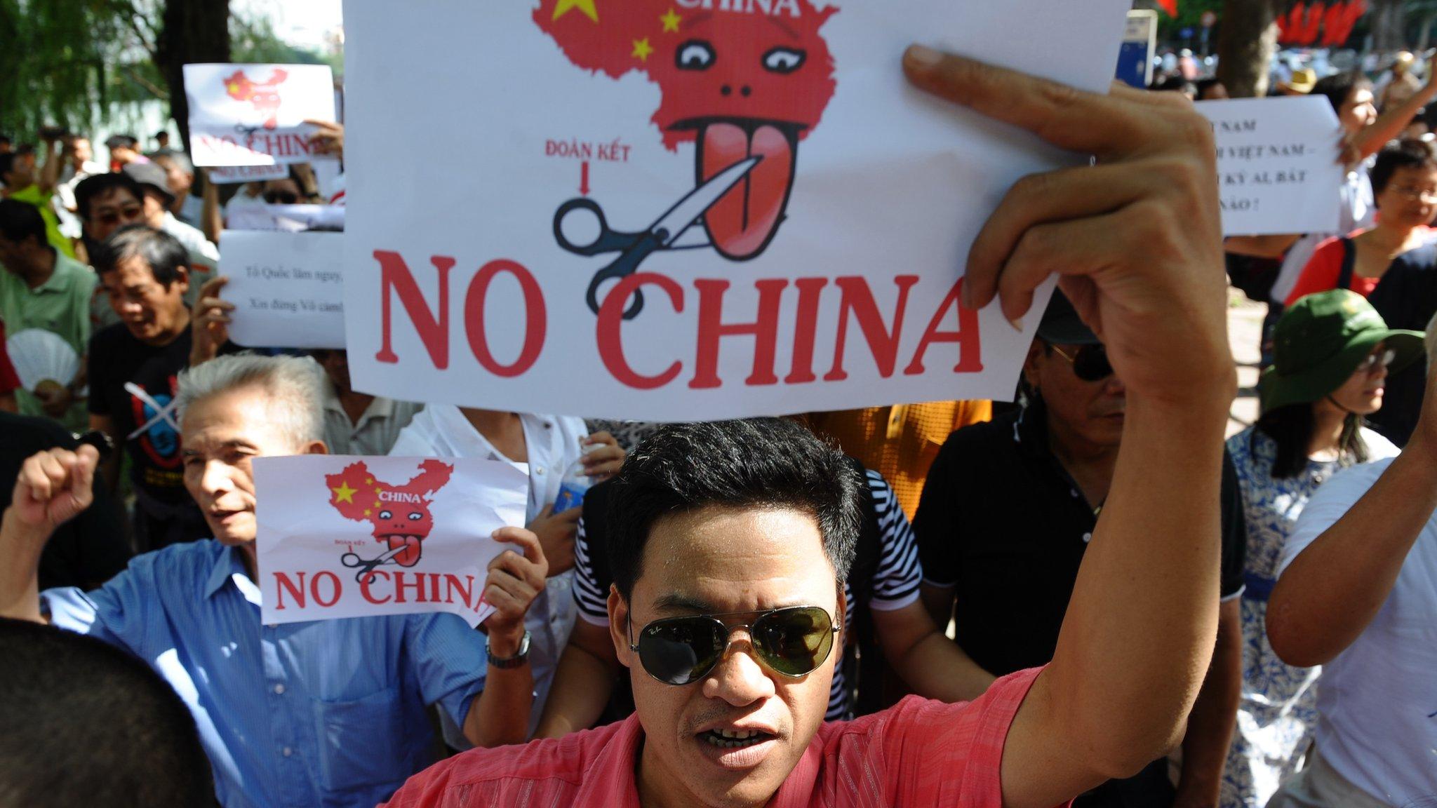 Vietnamese protesters shout anti-China slogans during a rally in the centre of Hanoi on 14 August 2011