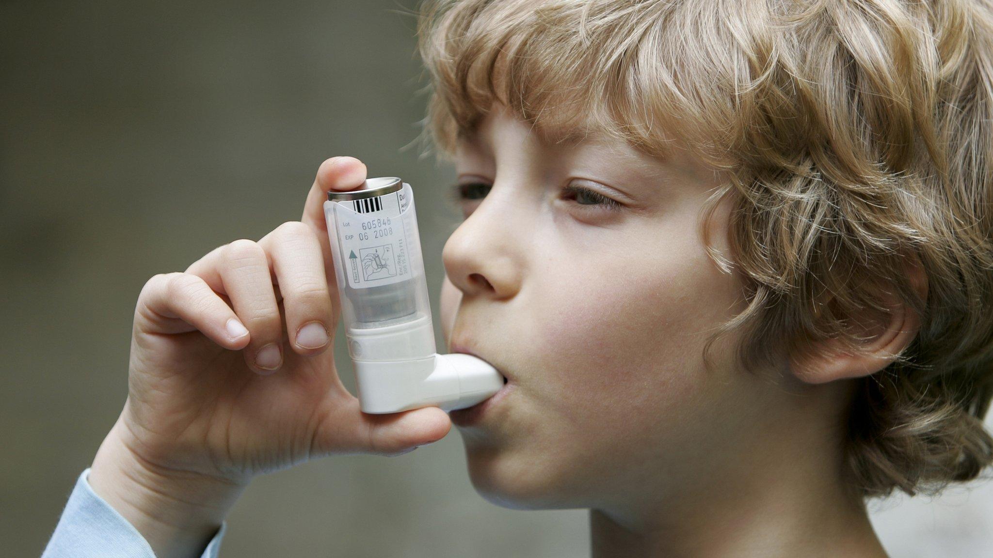 Child using asthma inhaler