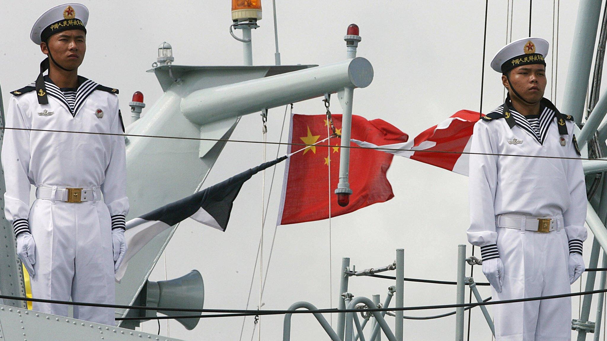 Chinese navy sailors stand guard on board a vessel at a naval base in Hong Kong (file photo)