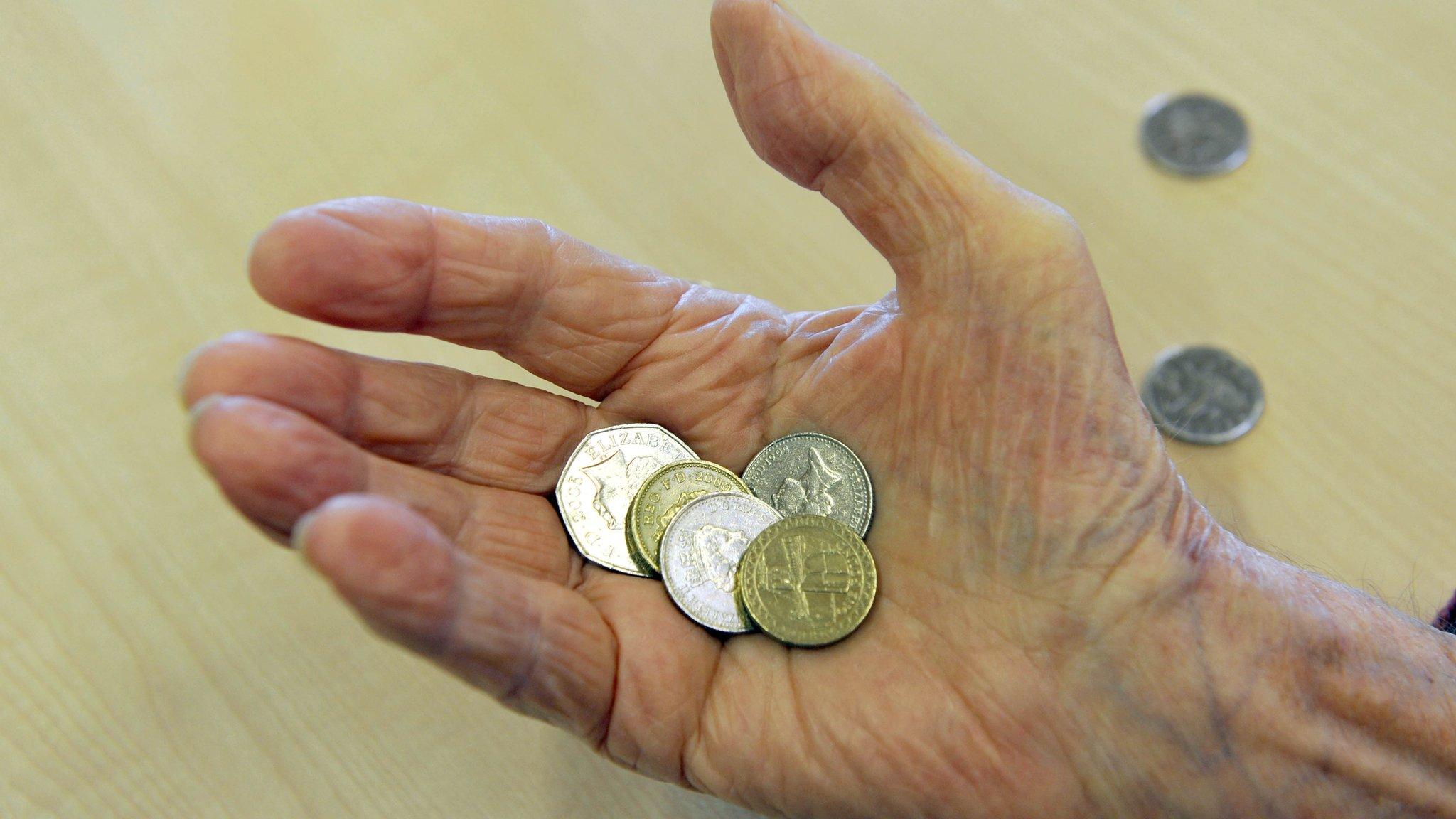 Pensioner holding coins