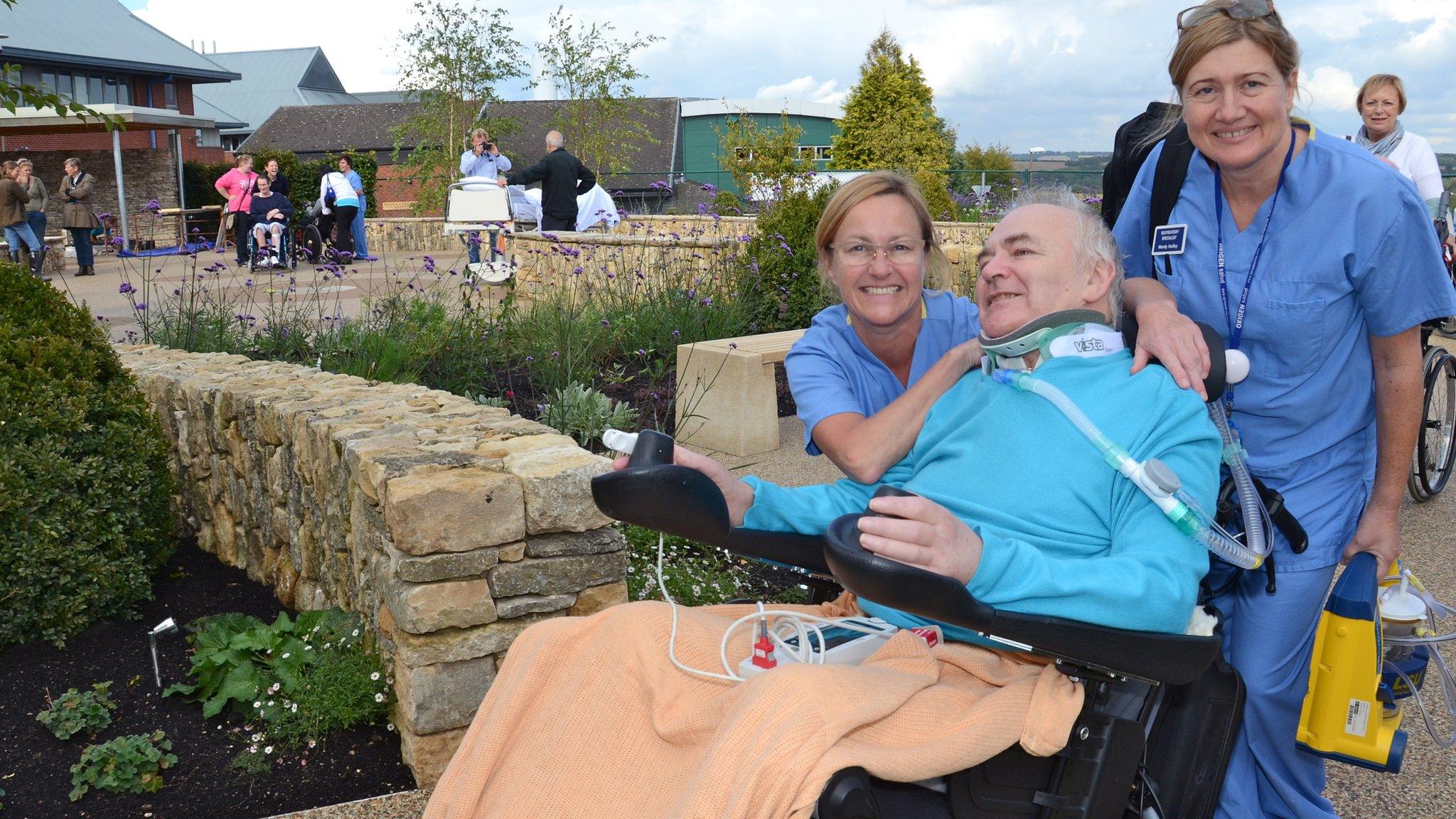 Two nurses with a patient in Horatio's Garden