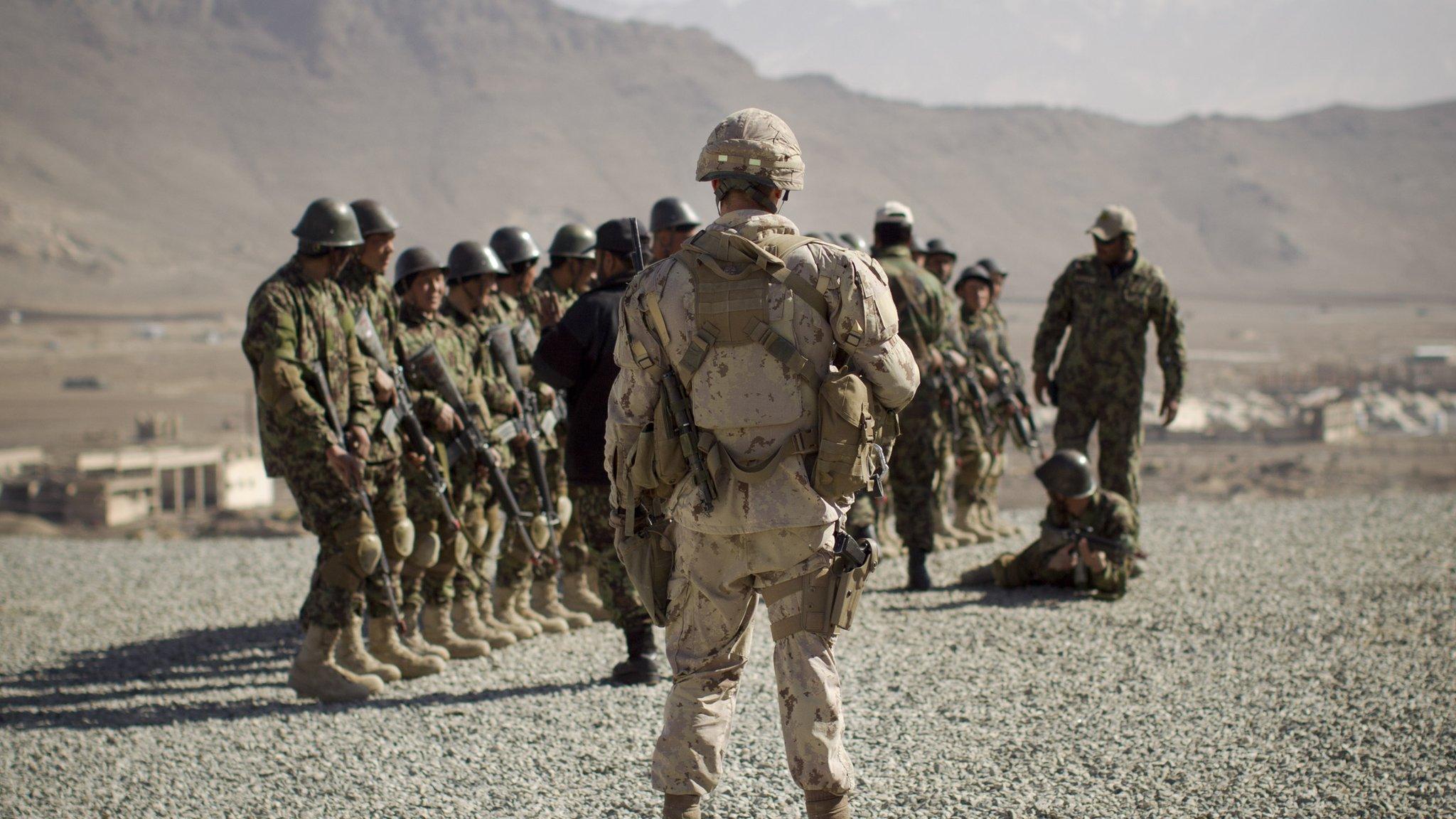 A Canadian Army soldier, mentoring the Afghan National Army