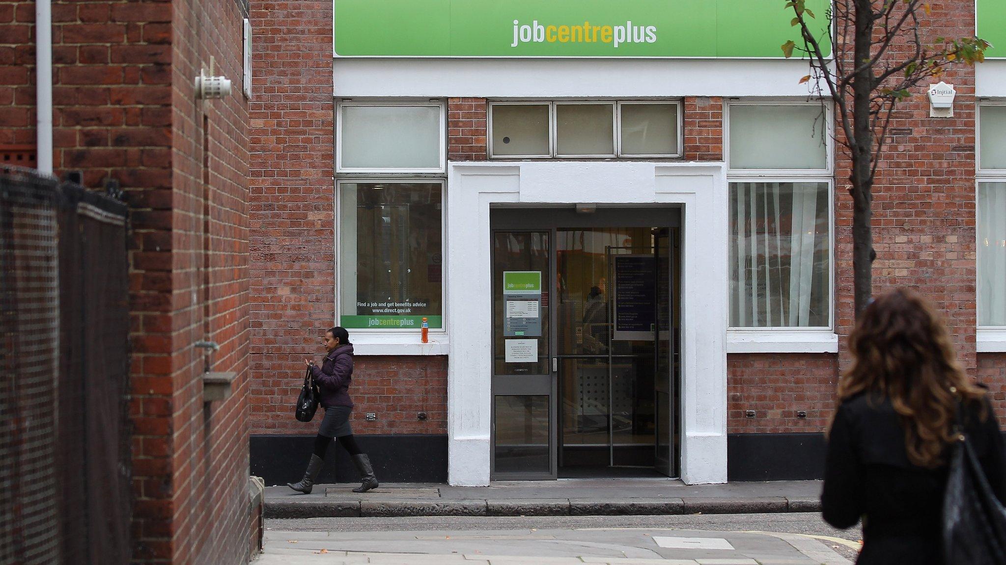 Woman walks towards Job Centre Plus