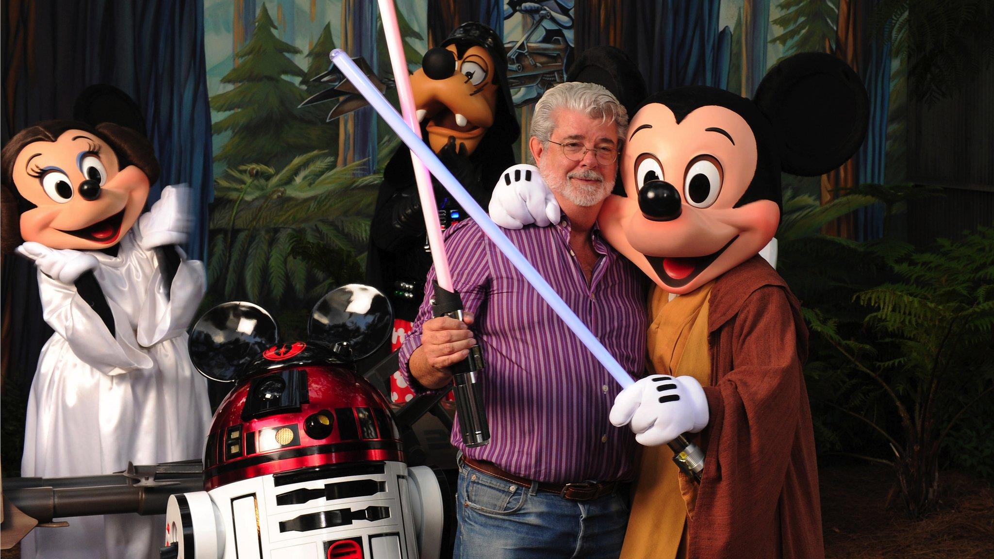 George Lucas poses with Star Wars inspired Disney characters in 2010