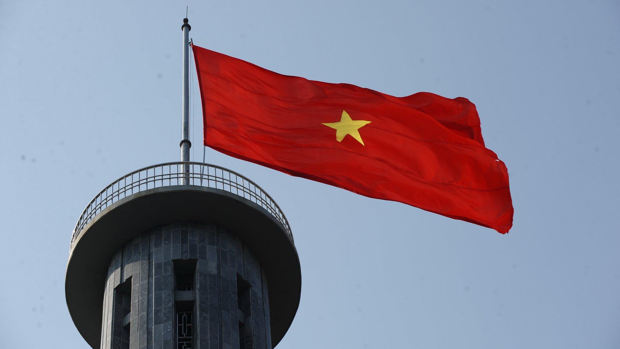 A Vietnamese flag flying at a tower near the country's border with China in Dong Van district, Ha Giang province, 8 March 2012