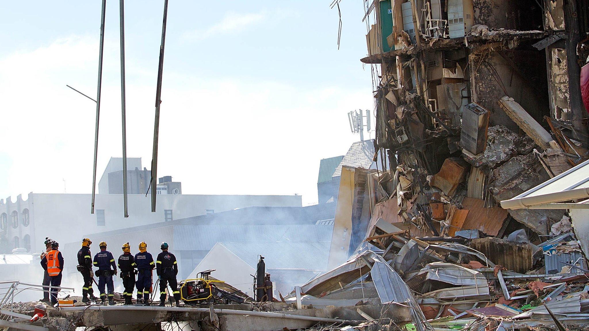 Rescuers at the smoking ruins of the CTV building on 24 February 2011