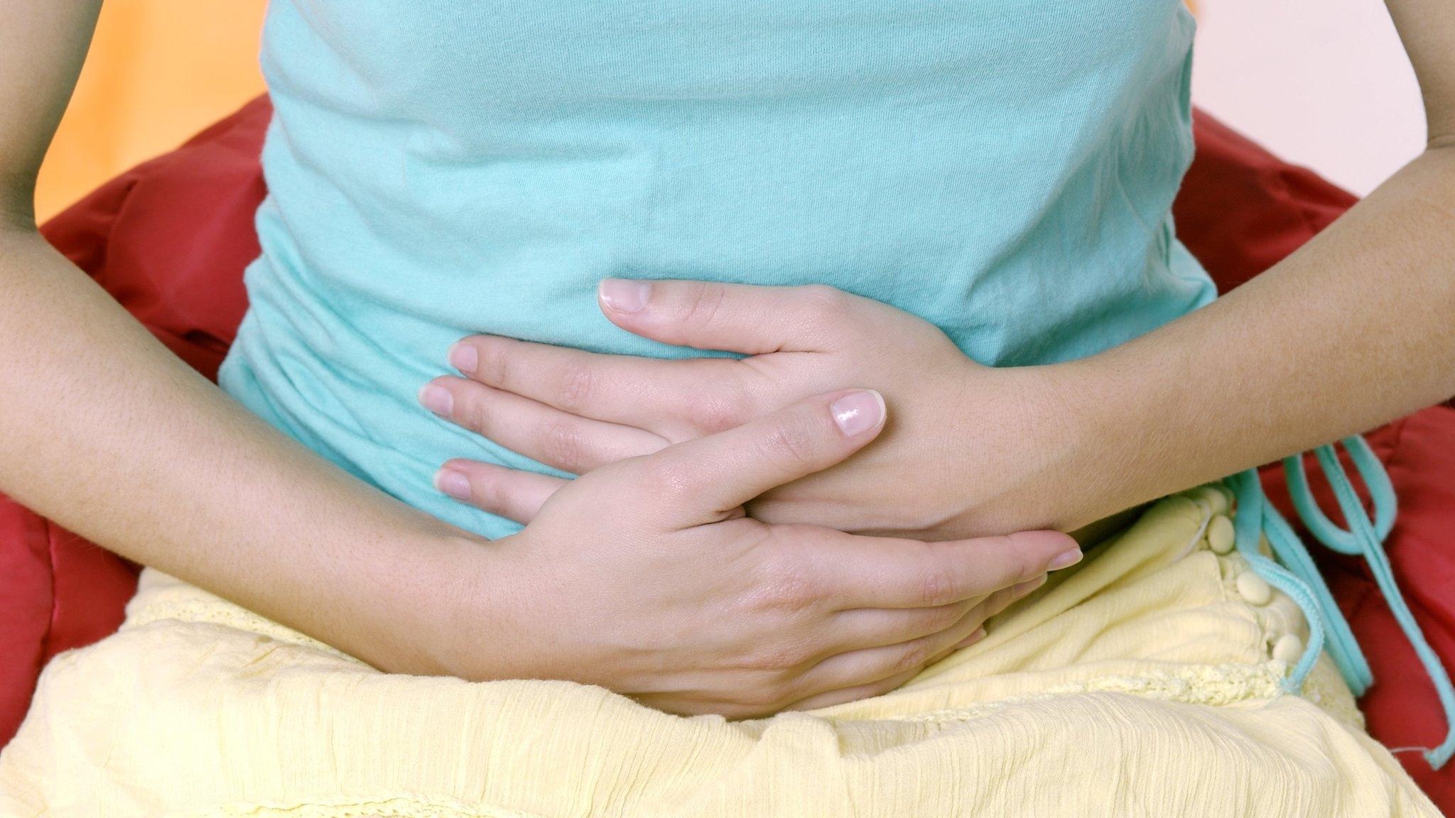 Woman holding abdomen