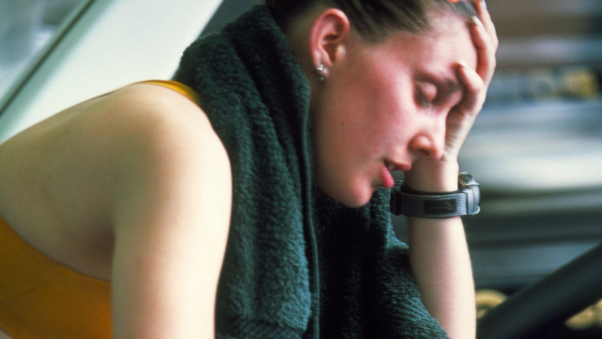 Tired woman in the gym